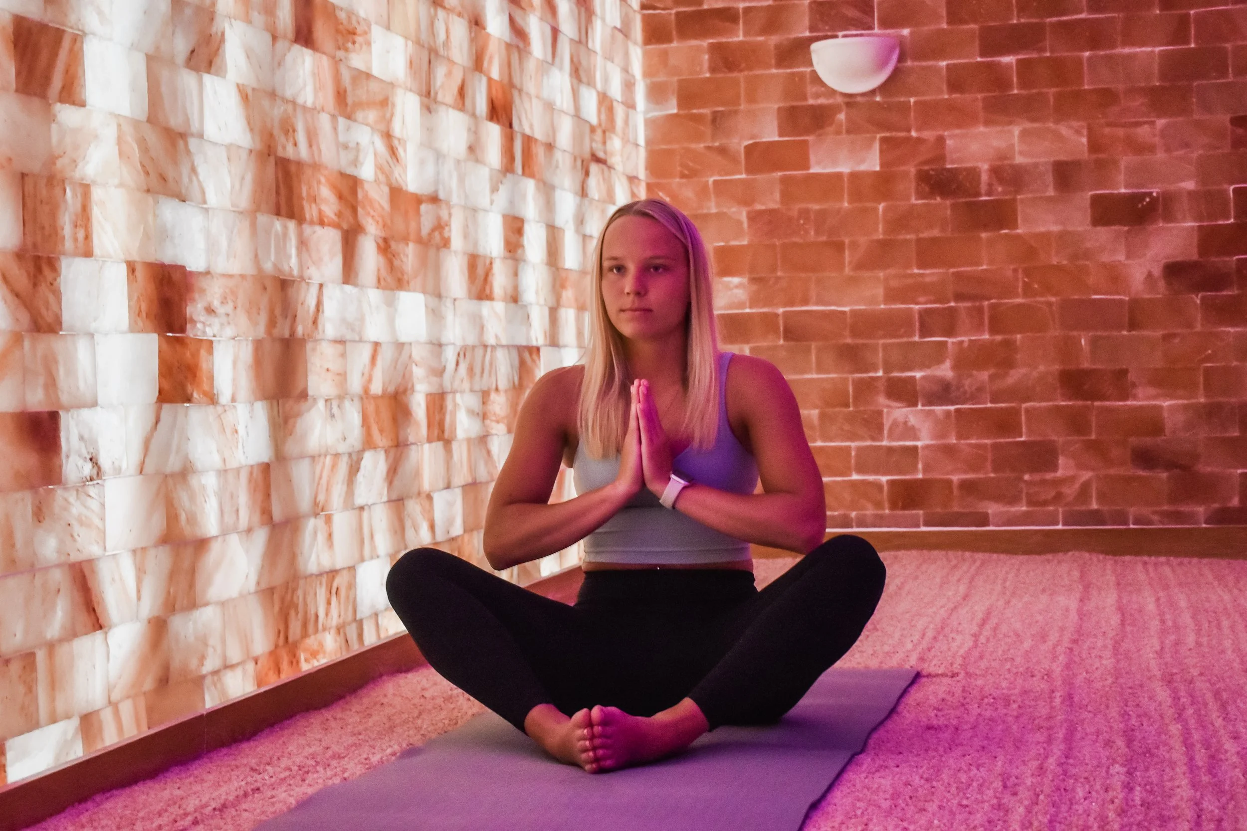 A young woman practicing yoga in a Himalayan Salt Room, Halotherapy Yoga, Vinyassa, Power Flow, Yin Yoga