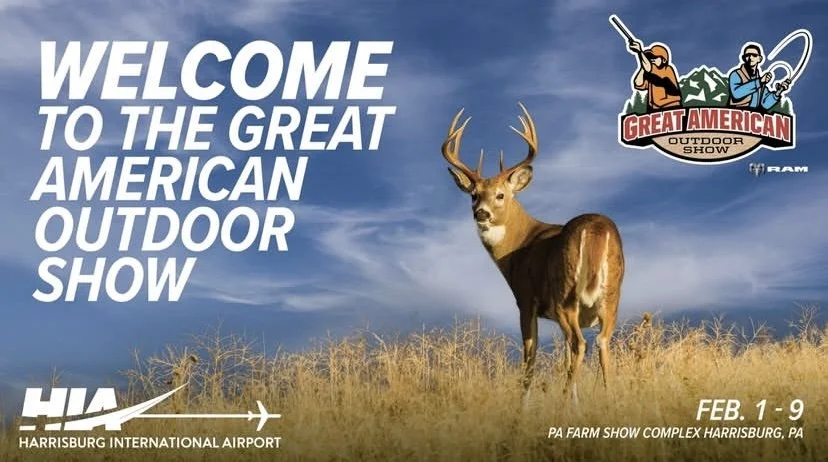 Advertisement for the Great American Outdoor Show with a background of blue sky and grass, featuring a deer and logos for the event and Harrisburg International Airport.