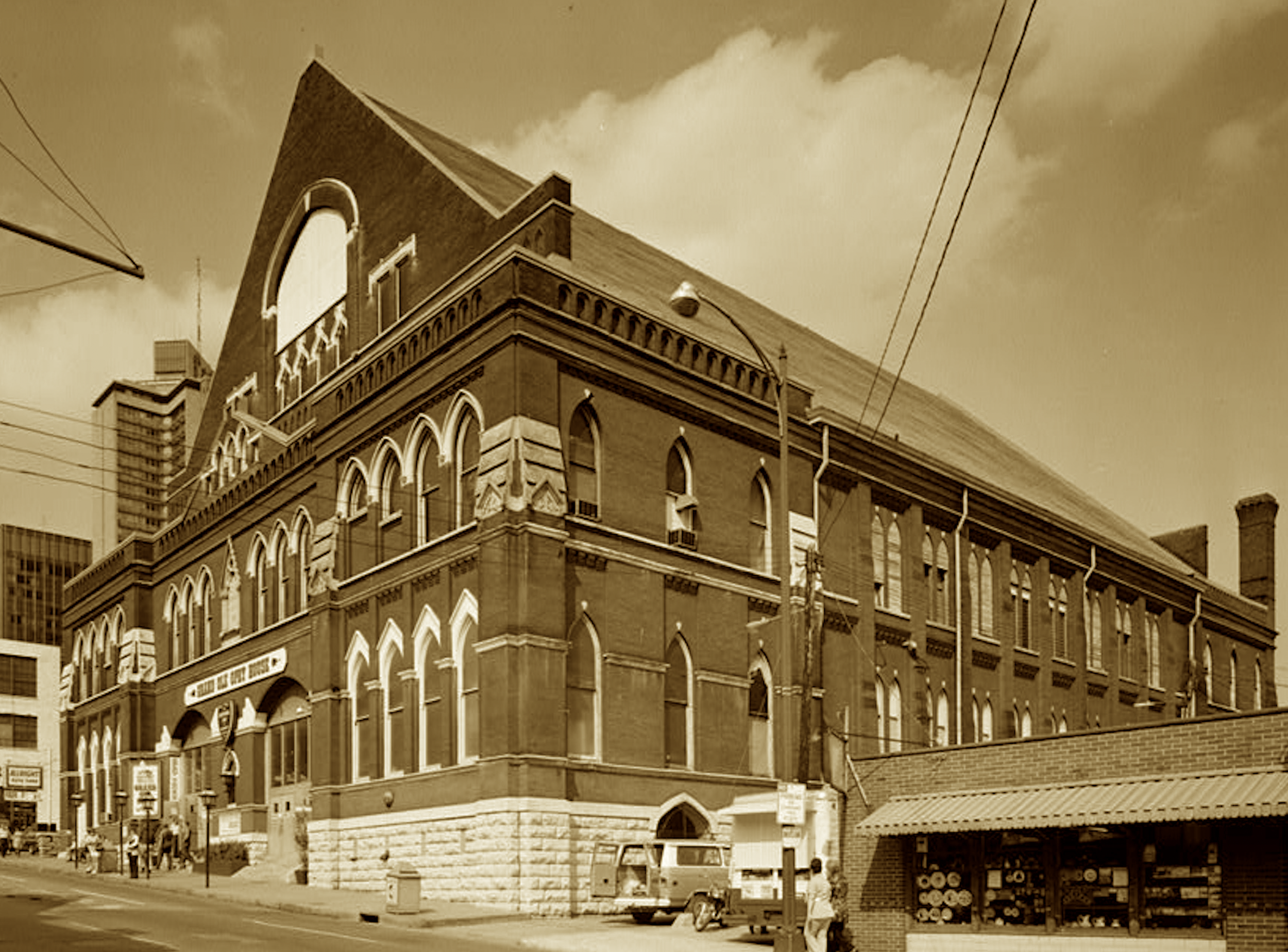 A steamboat man built pews and stage
That echoed gospel, fiddle, rage.
The Opry found its hallowed home
Beneath this Gothic-arched dome.
Now every chord and heartfelt plea
Still stirs the “Mother Church” in key.