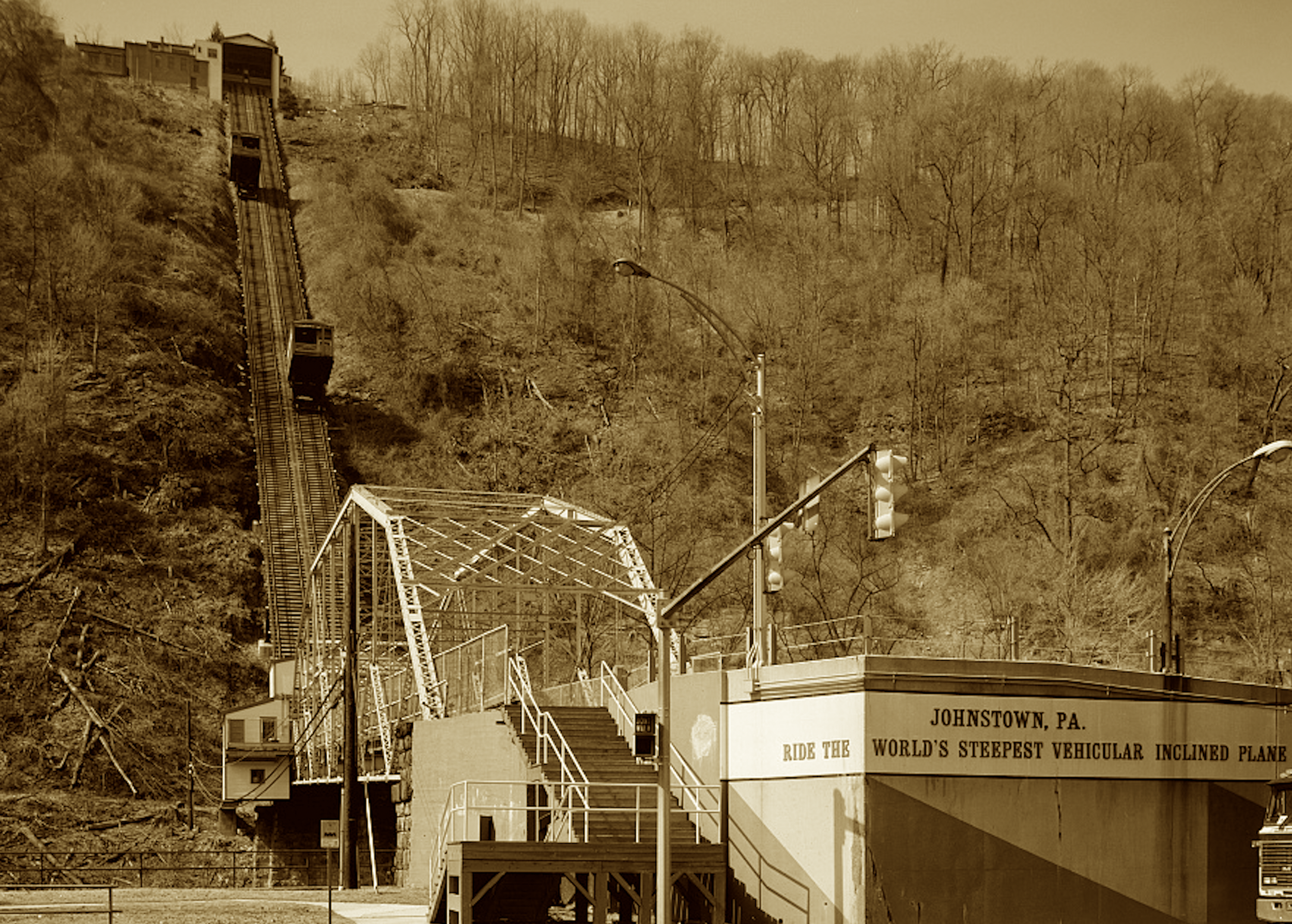 A rail that climbs the mountainside,
Where steepest grades let cars still glide.
It carried men to forge and flame,
Now tourists seek its storied name.
Climb up where steel once set the pace,
The slanted track still holds its place.