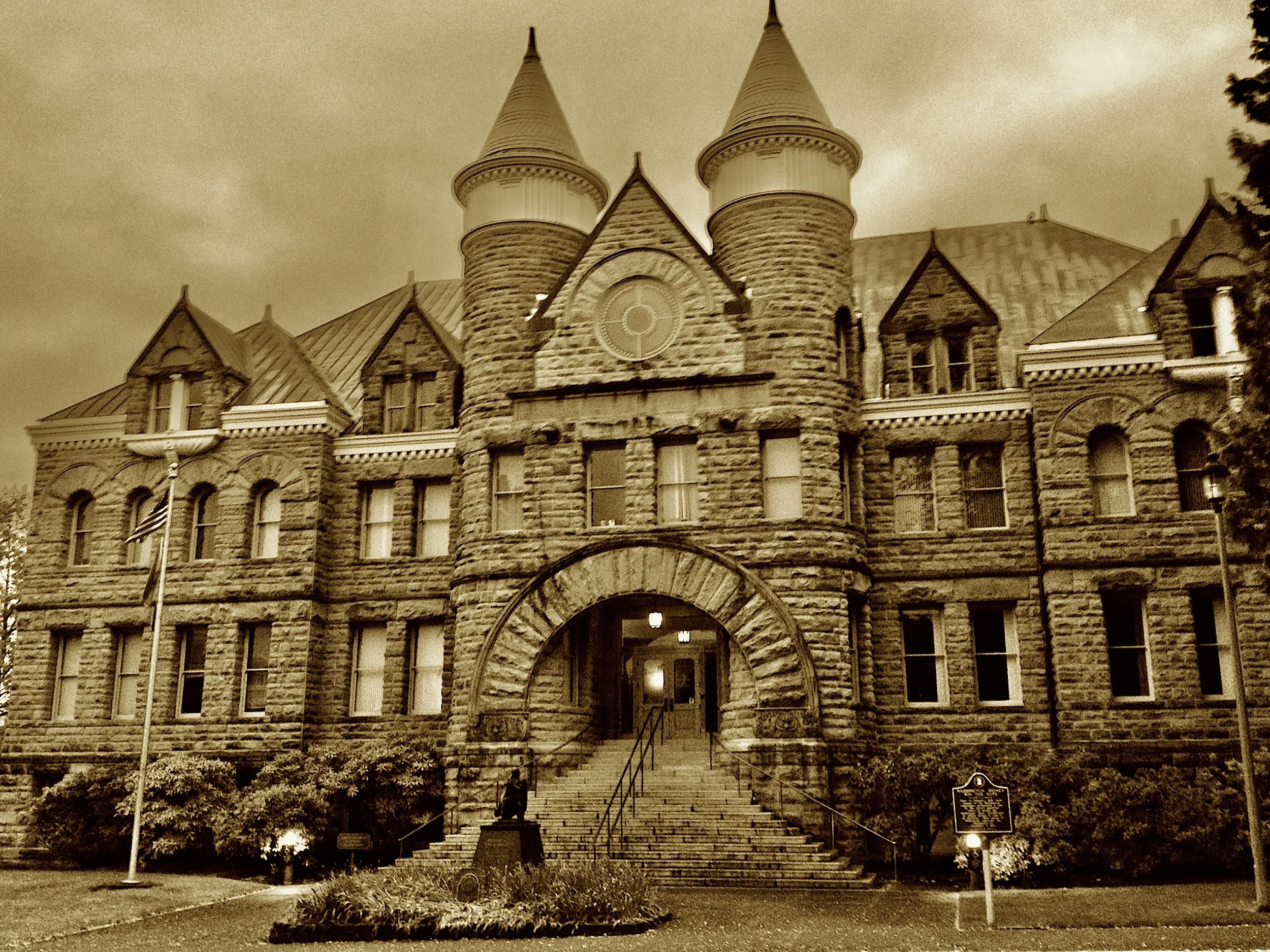 Chuckanut stone in commanding array,
Holds court from the days of Richardson's sway.
Once a courthouse, then Capitol grand,
Its gables and towers still proudly stand.
Though Olympia won the capital fight,
This sandstone castle still reigns in sight.