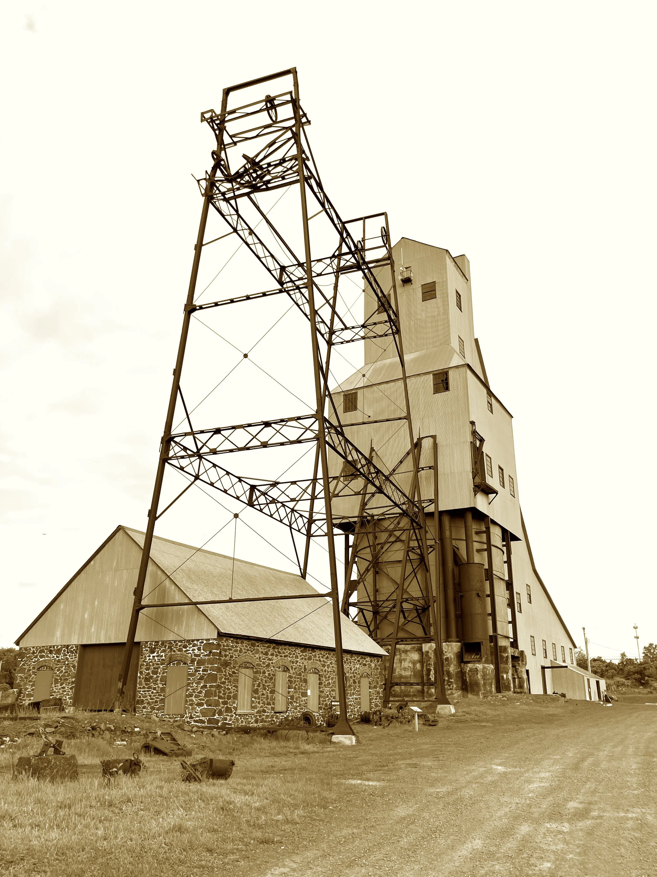 Where stamp and hoist met copper’s seam,
The deepest shafts once chased a dream.
Old Reliable, the mine they praised,
With hoists so vast they left folks dazed.
Now silent gears and timbers groan,
In tribute to the copper zone.