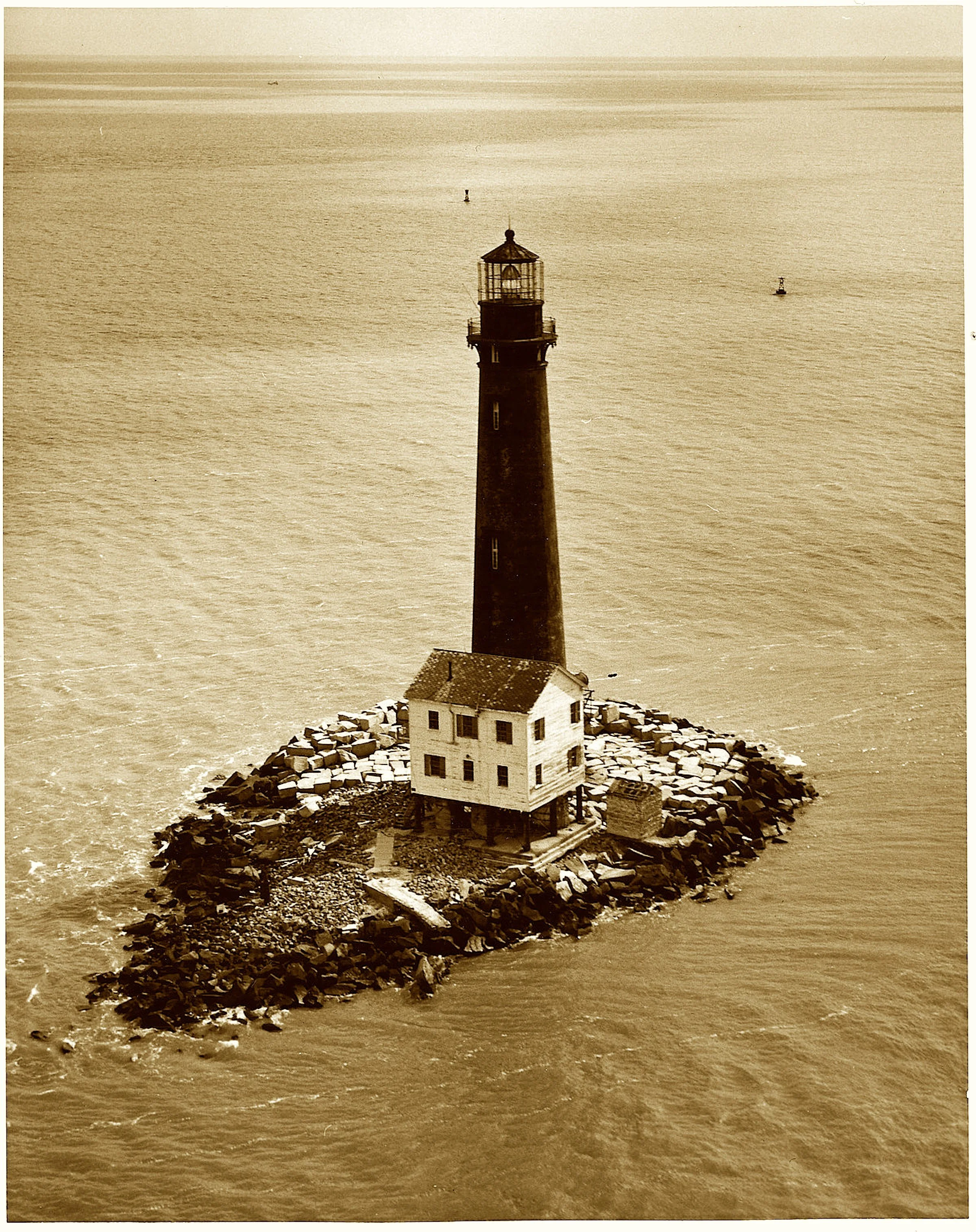 The island shrank, the waters rose,
But still that lonely beacon glows.
Blown up, rebuilt, replaced once more,
It marked the mouth of Mobile’s shore.
Now just a stump on granite bed—
Its keepers gone, its purpose shed.