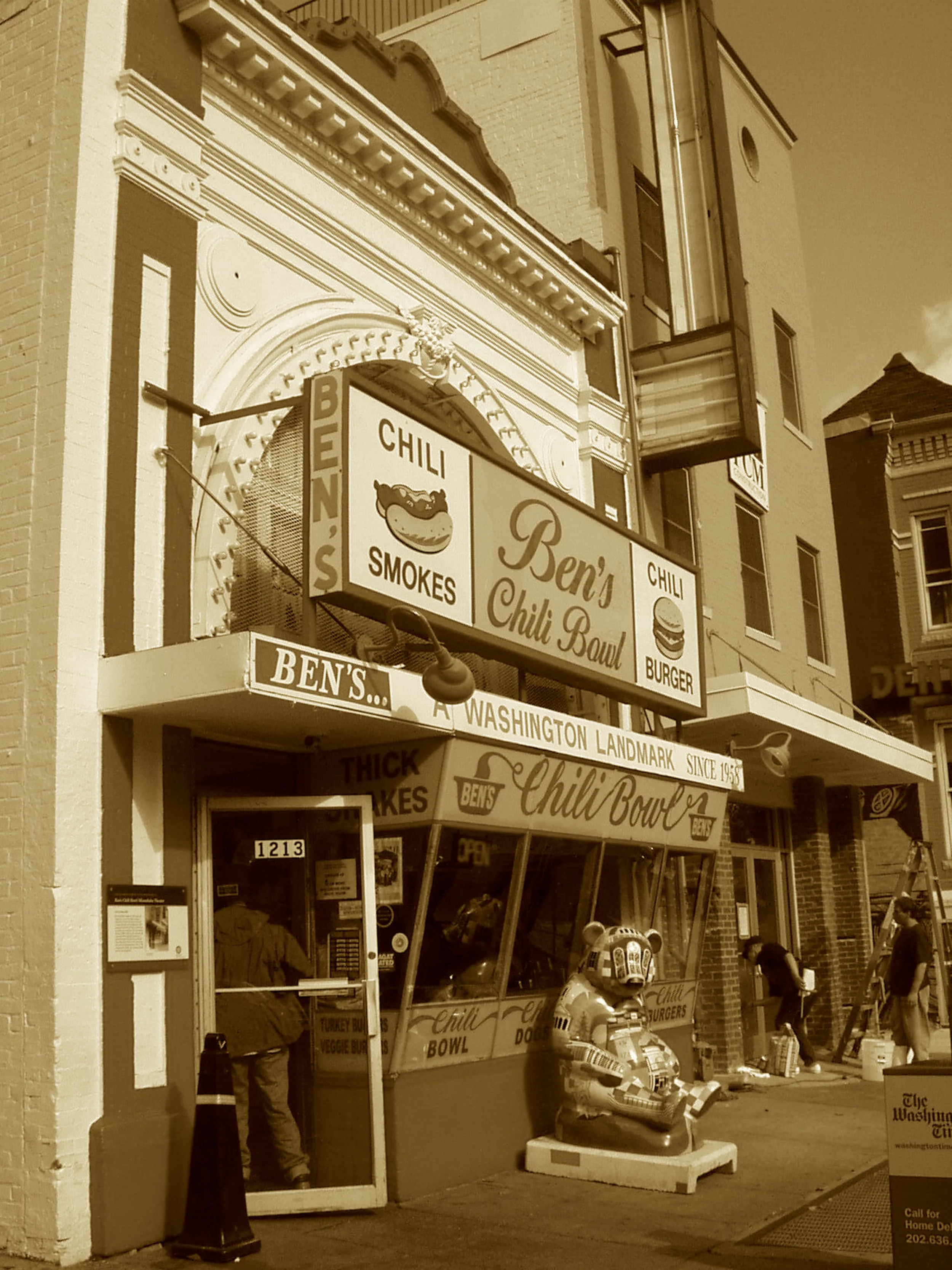 Where half-smokes meet with civil grace,
And legends fill the narrow space.
A kitchen forged in freedom’s flame
With chili, pie, and rising fame.
You run for office? Take a stroll—
No win without a stop at Ben’s Bowl.