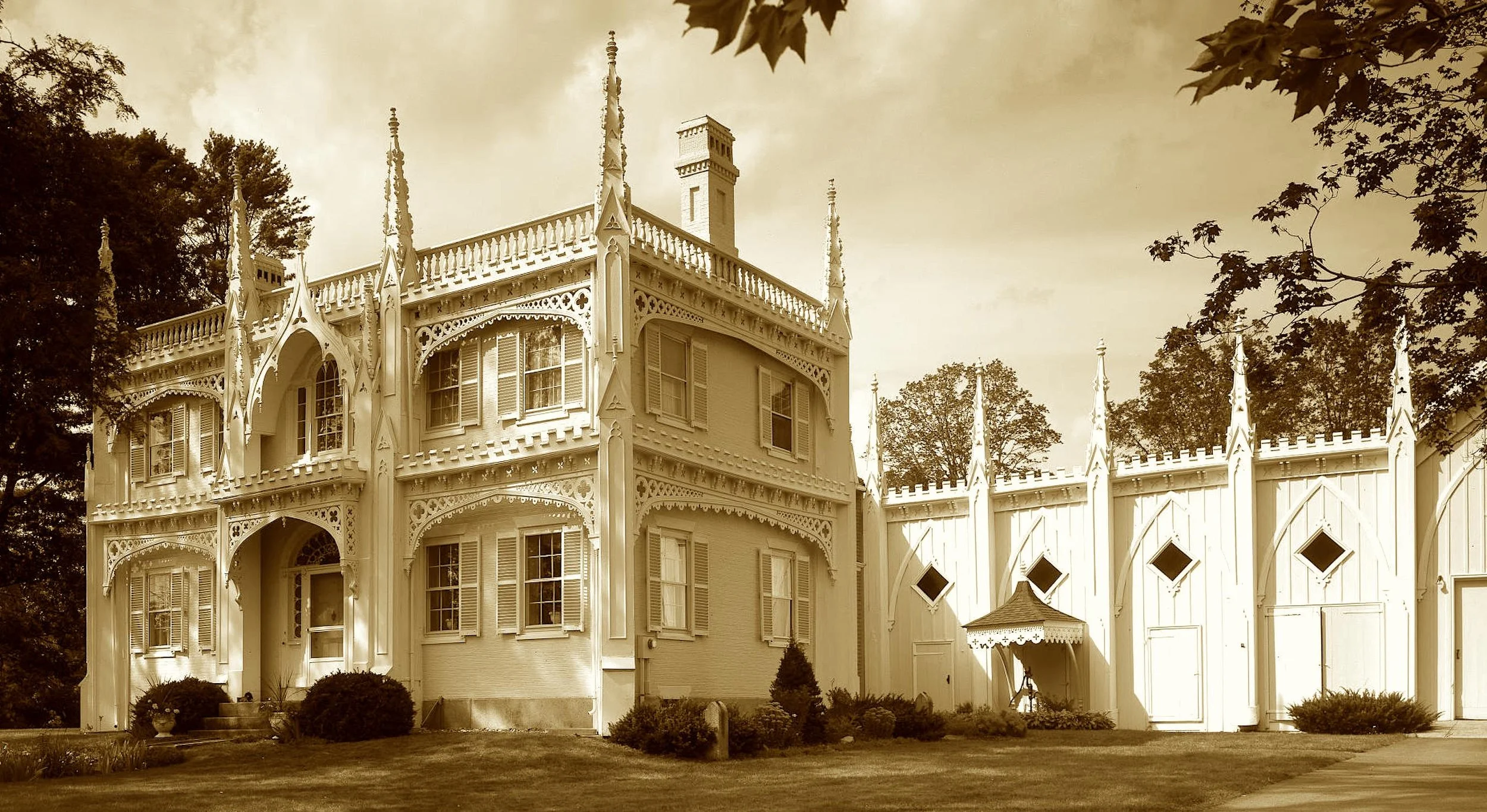 With frosting trim and turret high,
This house could make the angels sigh.
From shipwright hands the scrollwork poured—
A gingerbread dream long adored.
Now lovers pose and brides elope—
Sweet icing swirls on steepled hope.