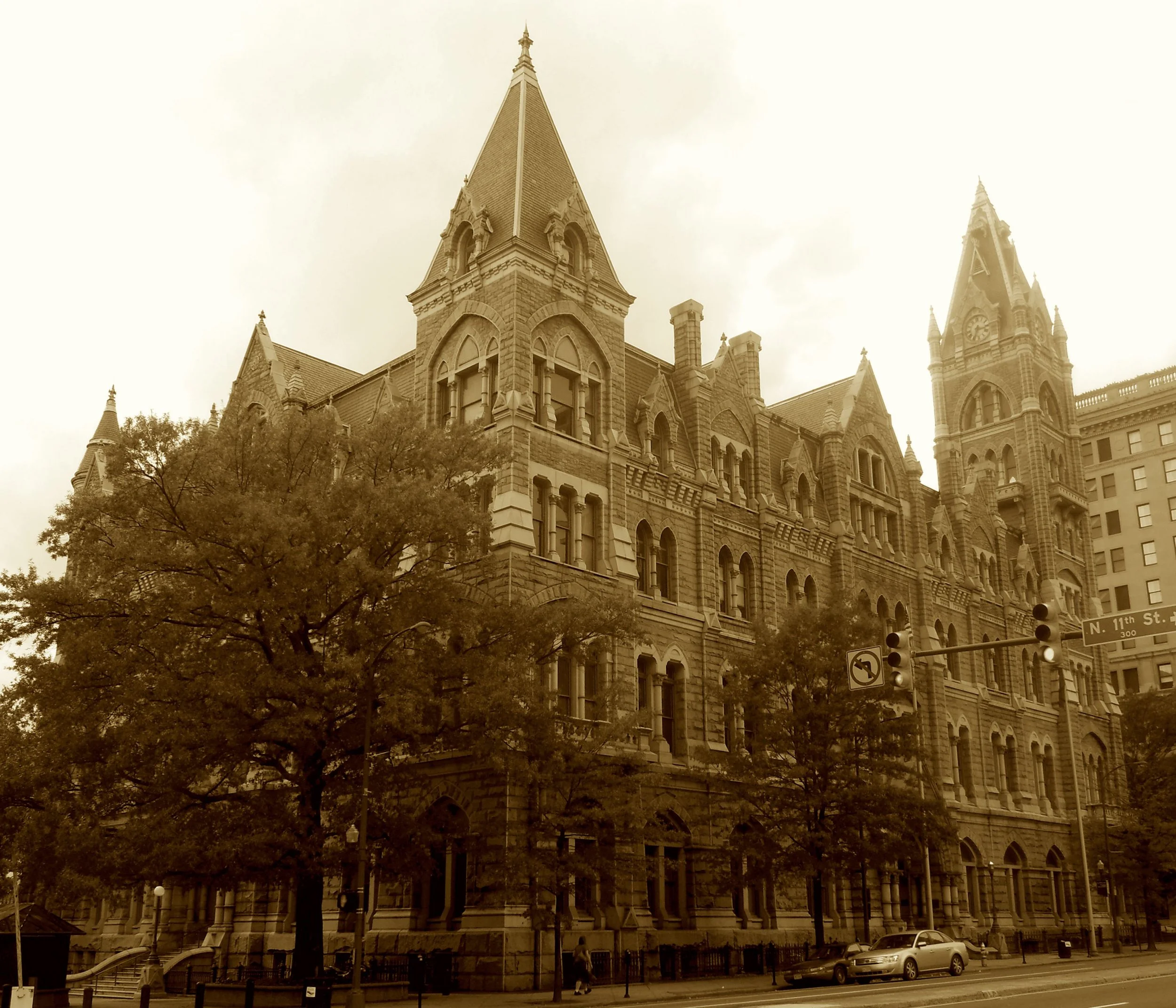 A Gothic pile of local stone,
Where spires and granite muscle shone.
The price ballooned, the schedule slipped,
But not a single frill was skipped.
Now offices fill halls once grand—
A civic dream carved by hand.