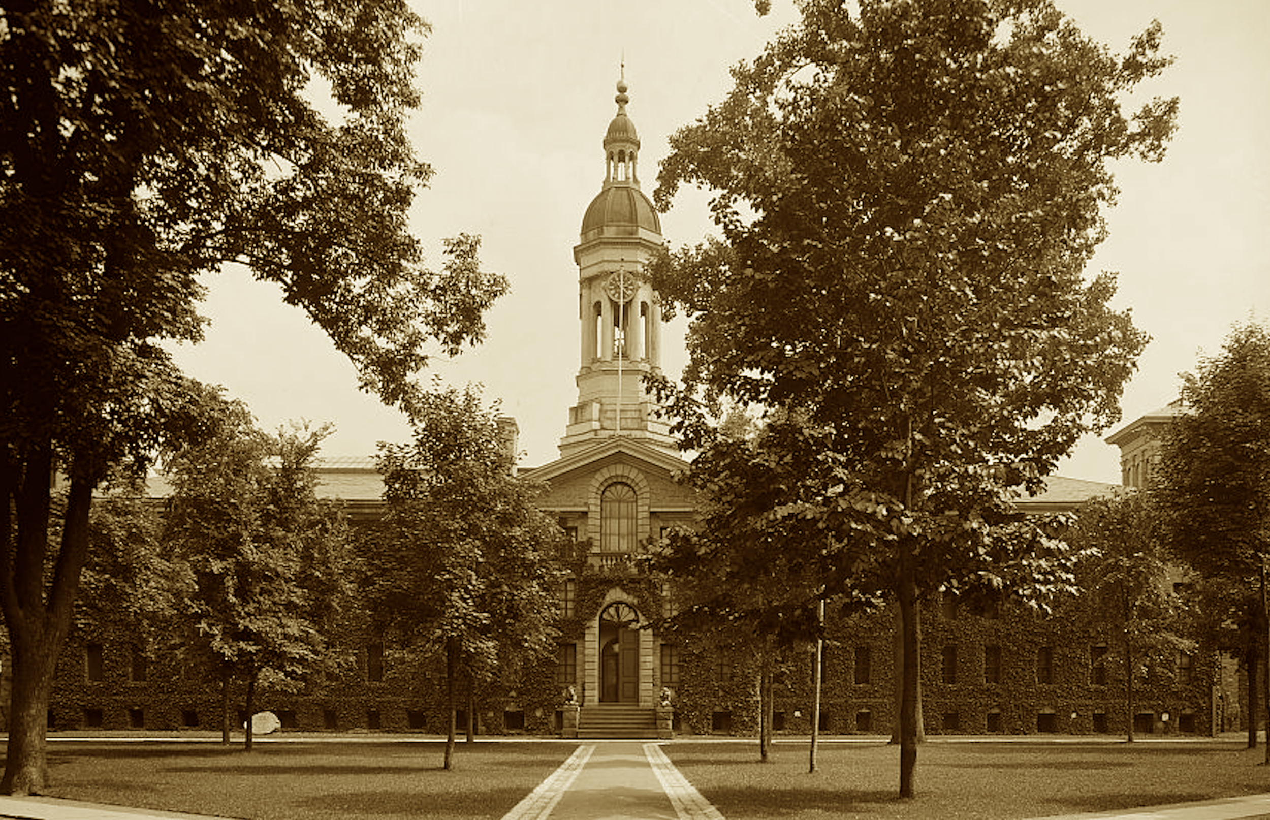 A hall of stone, a bastion wide,
Where cannon fire could not divide.
Redcoats fell and Congress came,
To steer a land through war and flame.
The tigers guard these hallowed halls,
Where learning rose as empire falls.