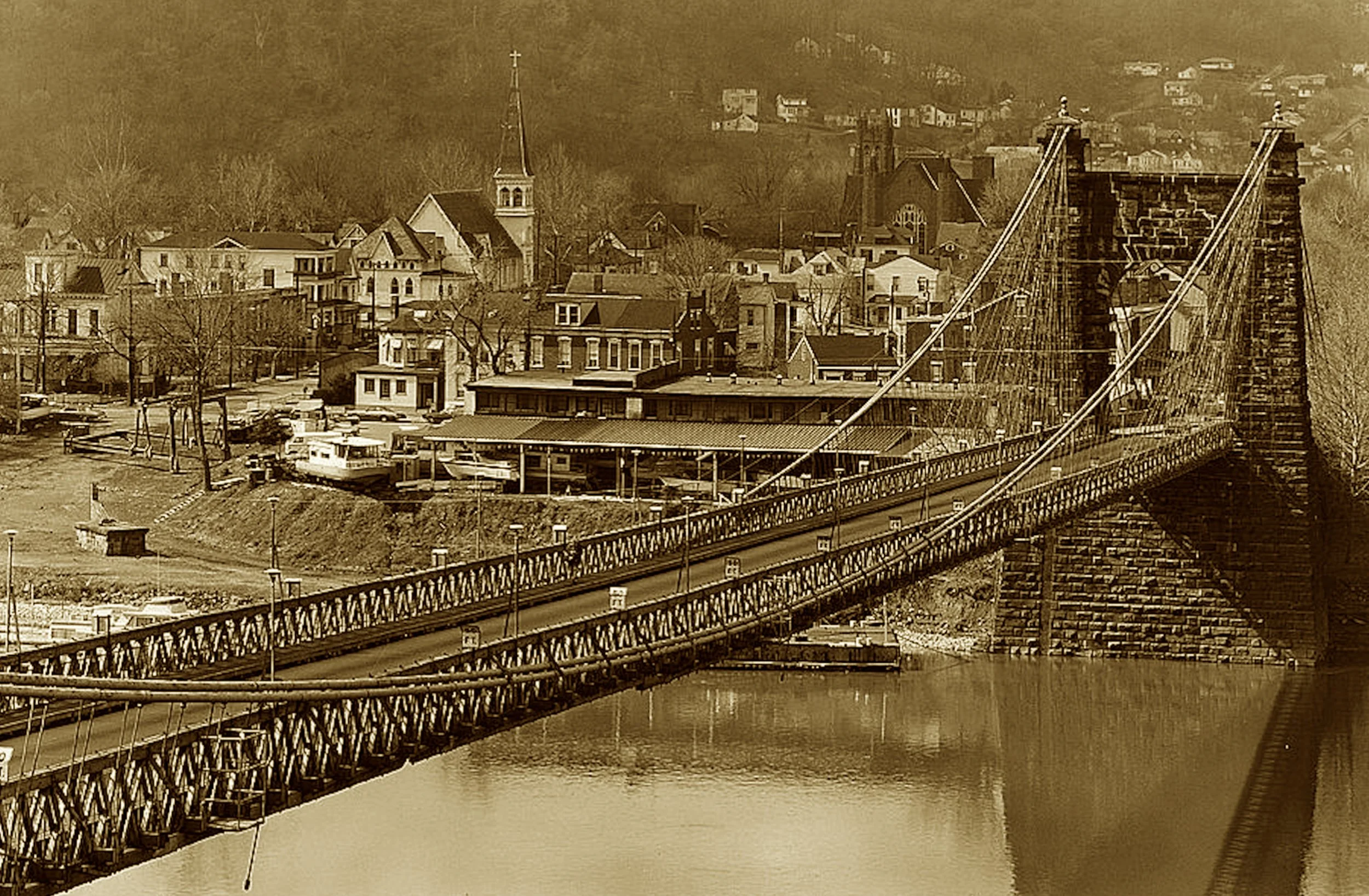 The river bowed, the cables soared,
A marvel that the law ignored.
It vexed the boats, but mail must move—
So Congress gave the bridge its groove.
Still standing proud with graceful span,
A triumph wrought by iron and plan.