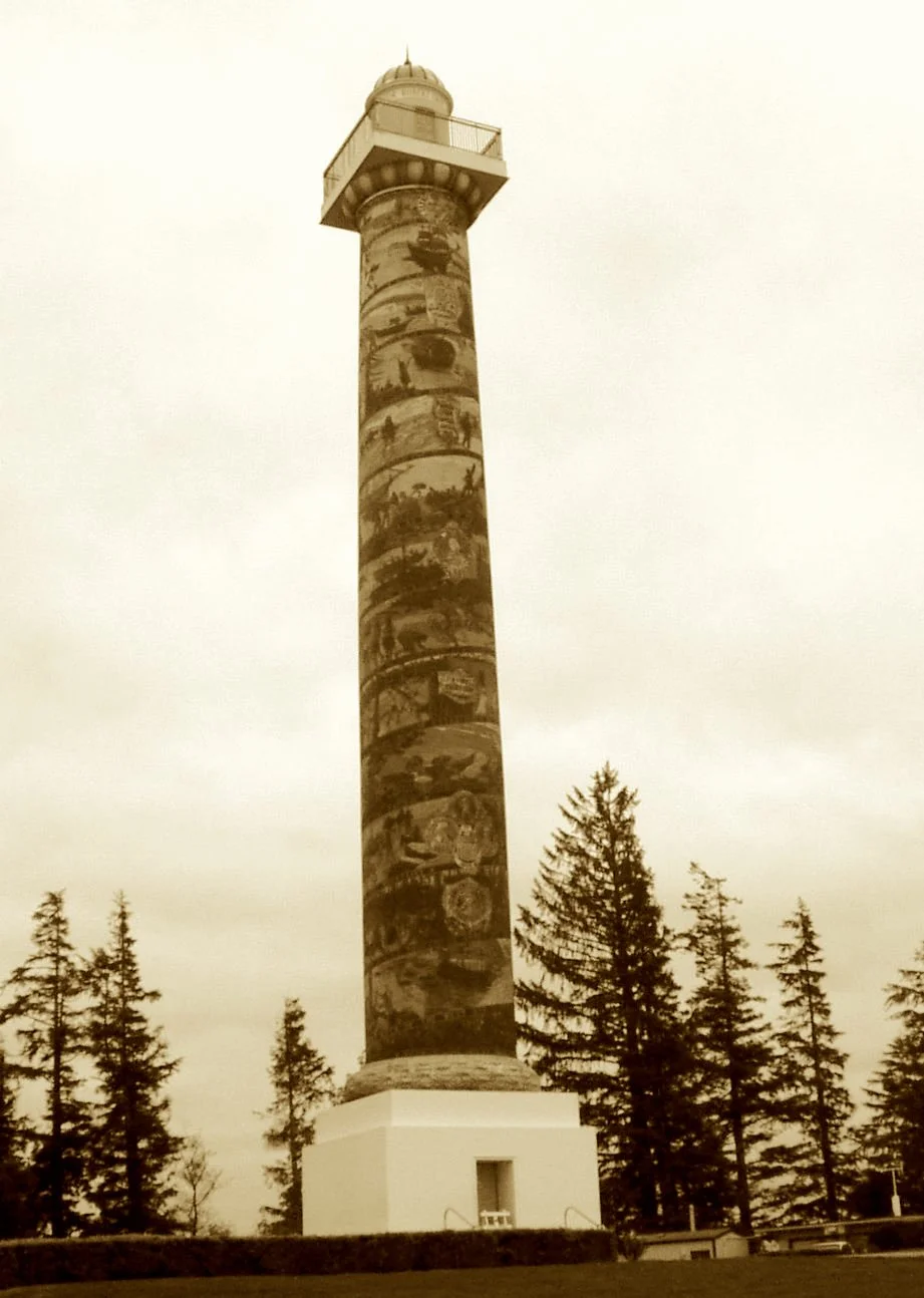 A spiral of tales on a column so high,
Tells Oregon’s journey through clouds in the sky.
Sgraffito murals climb up with the years,
From Gray’s mighty ship to pioneers’ cheers.
A lighthouse of history, beacon of pride—
Where Pacific winds and timeline