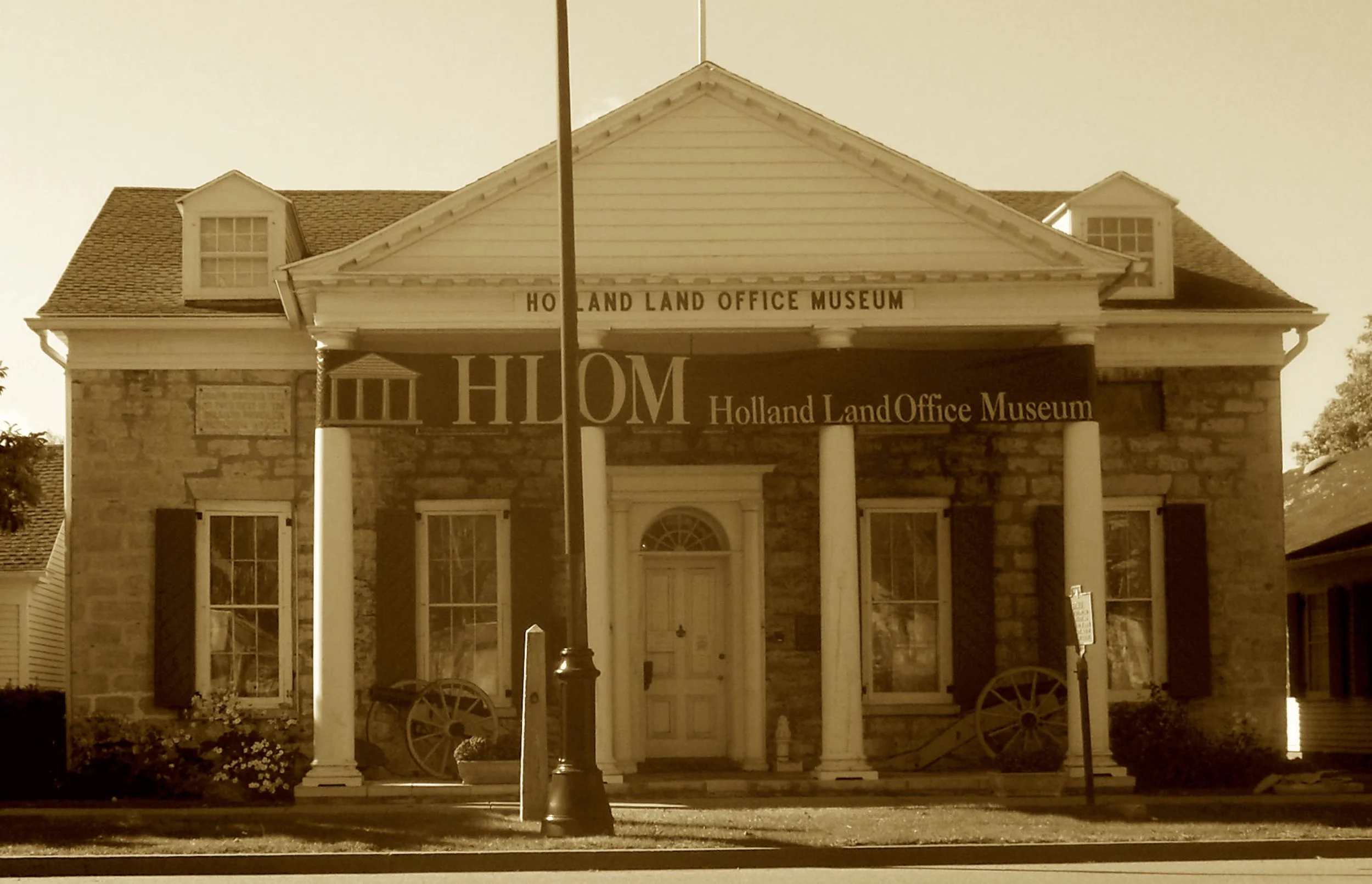 Where maps and deeds were locked up tight,
In limestone walls of gray and white.
The Holland investors made their claim,
As westward settlers staked their name.
Seek this office once lined with cash—
Now a stone vault of historic stash.