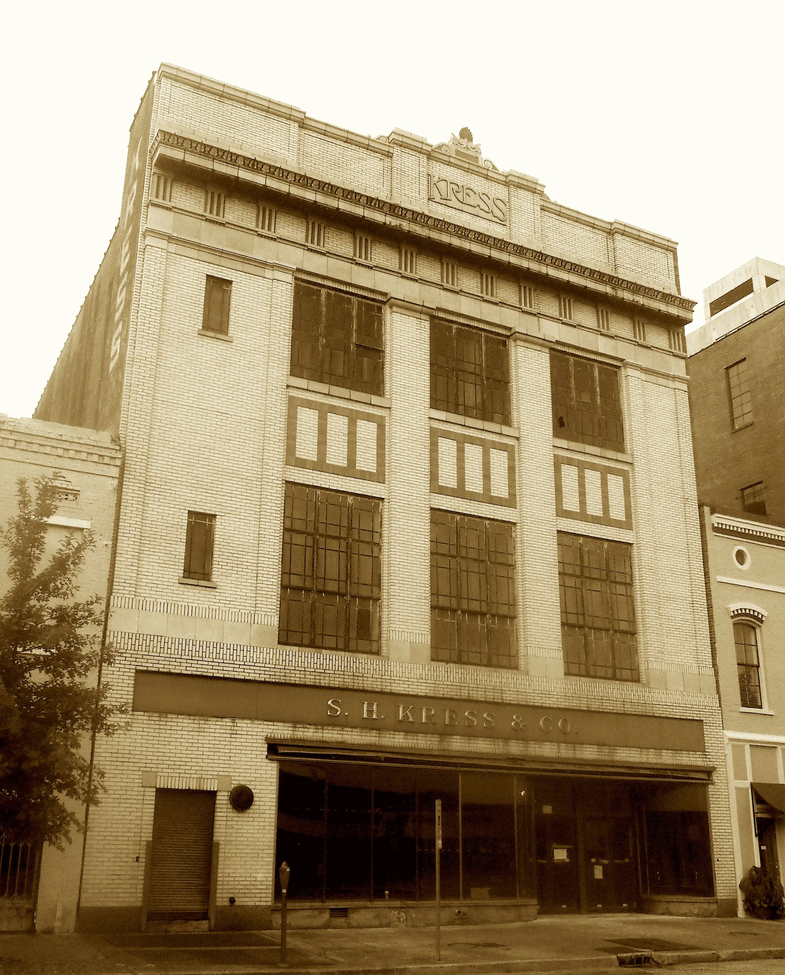 Where five-and-dimes were dressed in gold,
And art met commerce, brave and bold.
With twin façades—one Deco’s dream,
One Doric, carved in classic theme.
Sam Kress sold goods and gifted grace—
A palace store in every place.