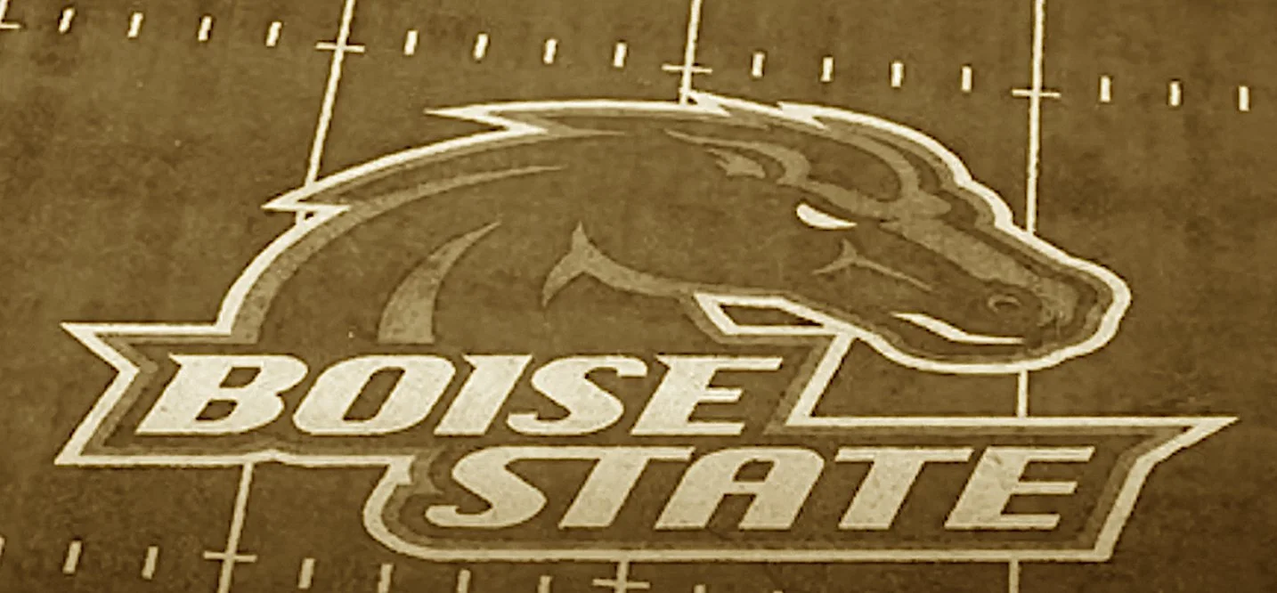 Where Boise’s turf turned bold and blue,
And football dreams came charging through.
From junior champs to bowl game clout,
They painted green tradition out.
Opponents wince at crowd and chill—
The spud state packs a mighty thrill.