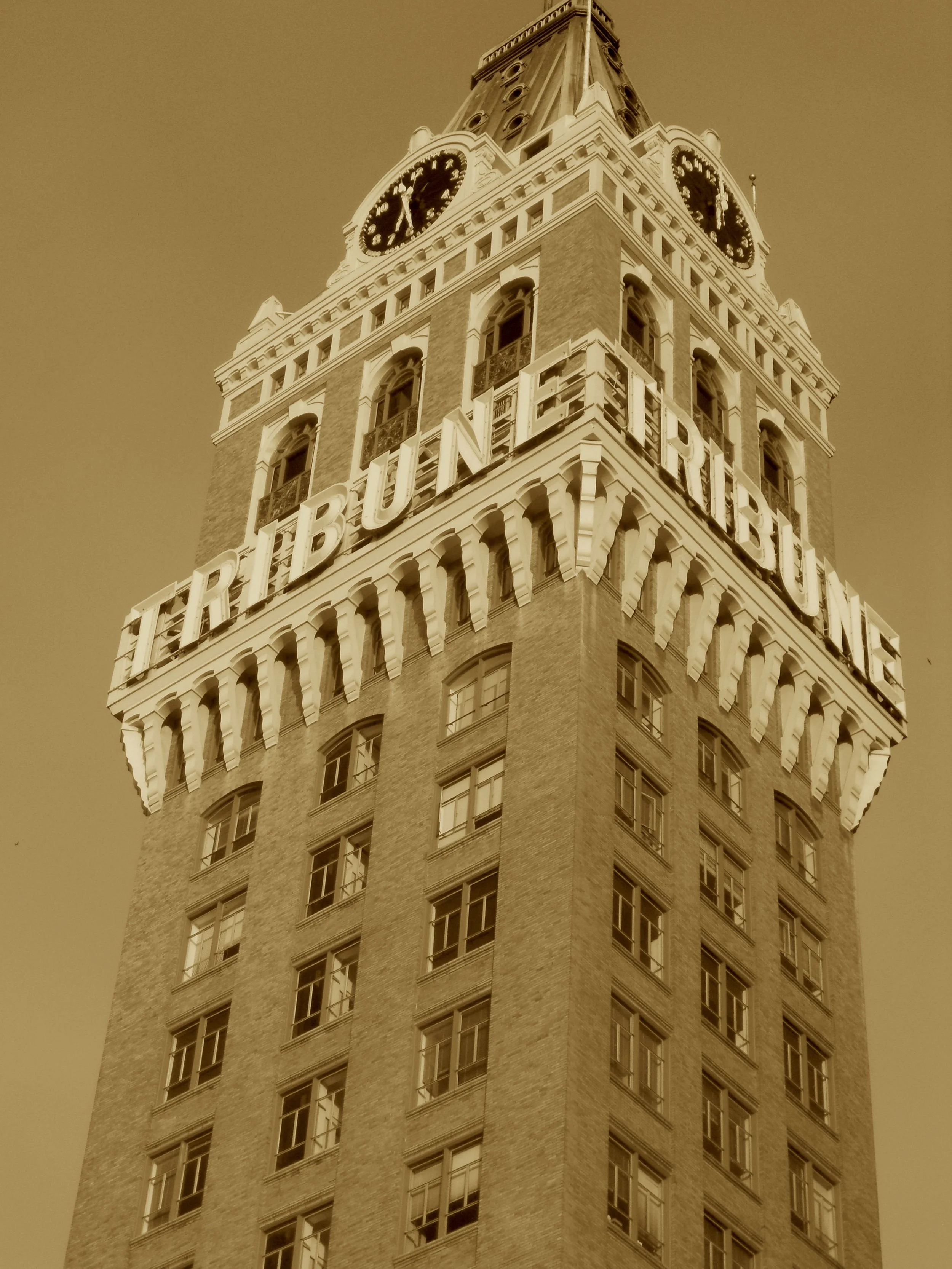 Where Houdini hung above the street,
A clock tower crowned the journal beat.
From furniture to front-page fame,
Oakland’s skyline took its name.
Though quakes may shake and papers go—
This Gothic spire still tells the show.