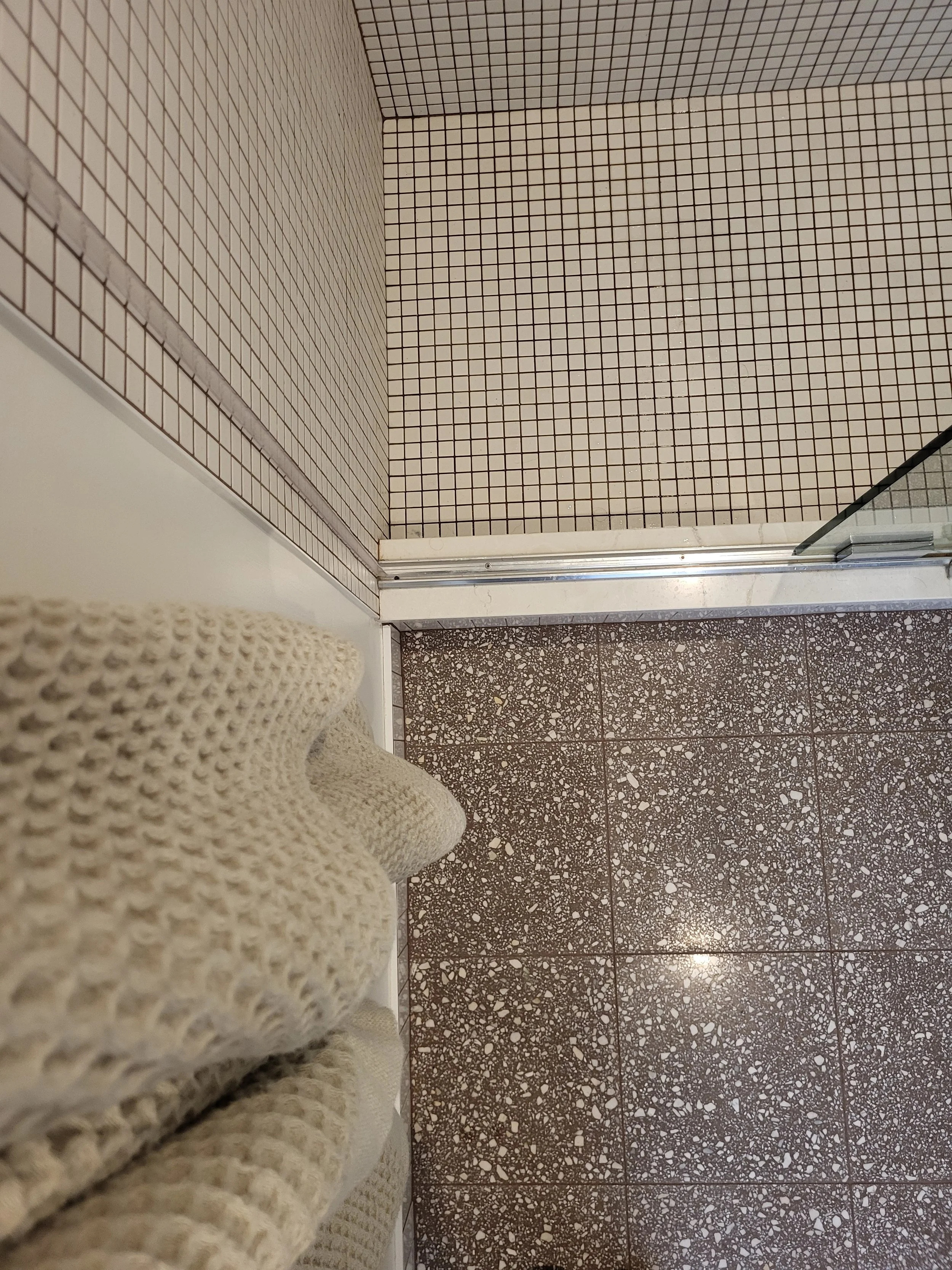 I love the repetition of patterns and the carry over of muted tones from the living space color palette into the bathroom. Floor tile: ZIA; natural stone remnant shower threshold; wall base: Fireclay; shower walls and floor: Daltile. I proudly source