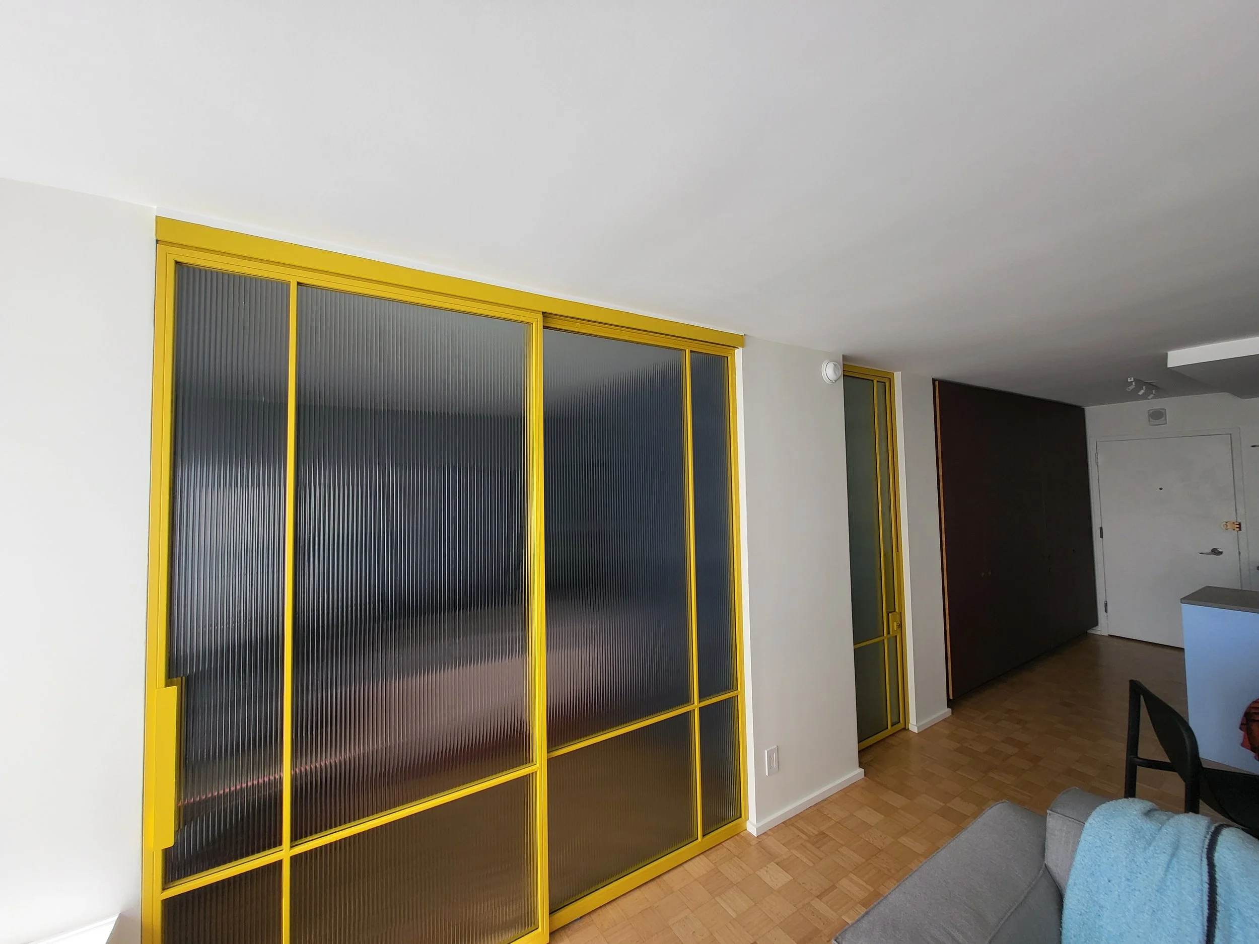 We maximized the height of the space by maintaining an uninterrupted line from the sliding door to the bathroom door to the top of the kitchen cabinets.