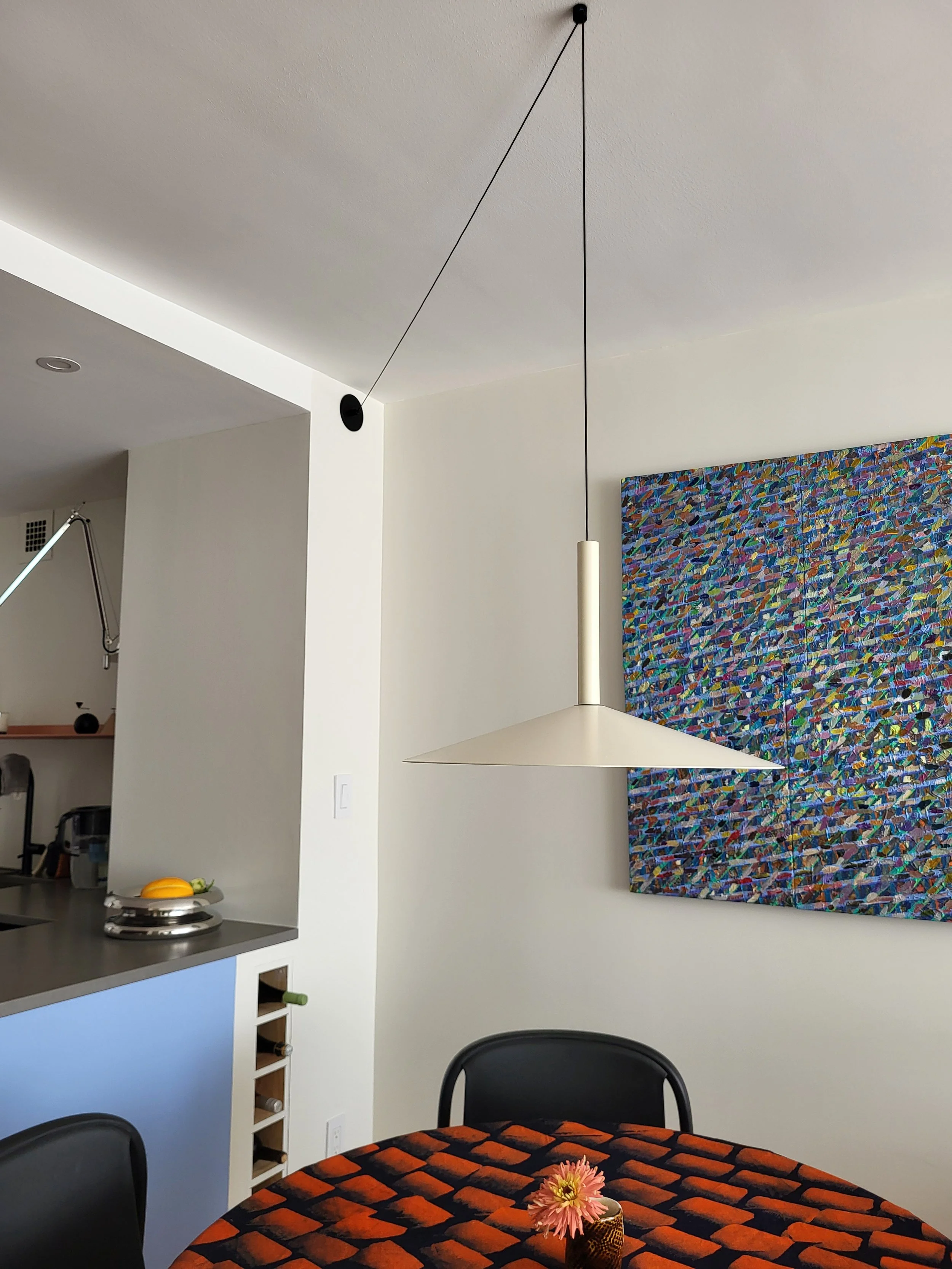 Marset pendant over an Ikea table and BluDot chairs. Custom made wine rack to make the most of 7" extra inches!