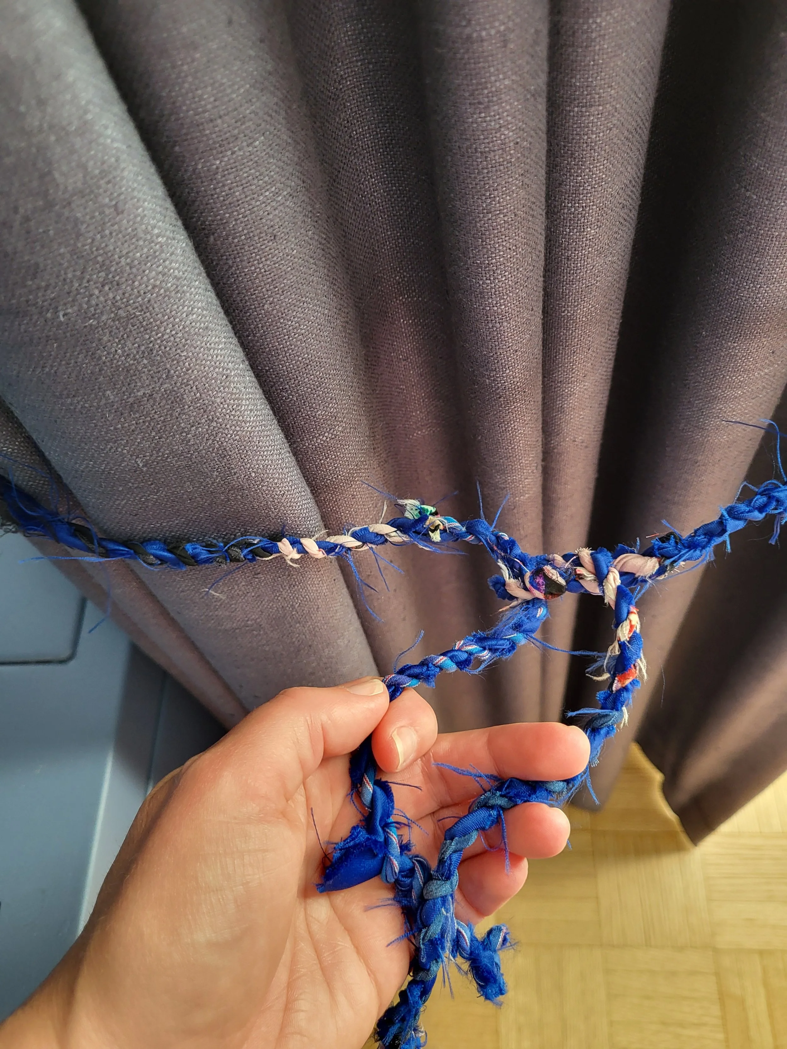 I learned how to make rope in a basket weaving course and made these curtain tie backs from an old silk top.