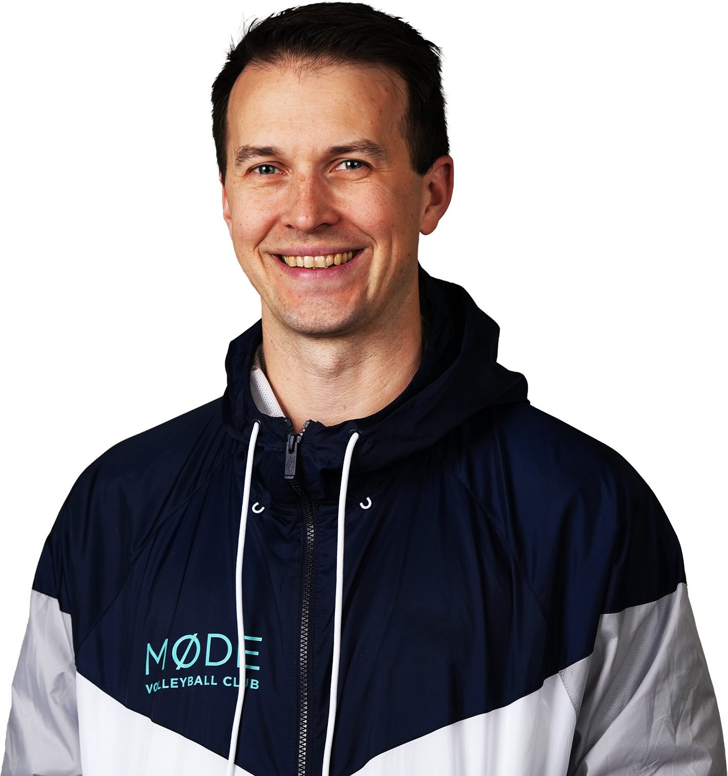 A smiling man wearing a navy blue and white sports jacket with the words 'MODE VOLLEYBALL CLUB' printed on it.