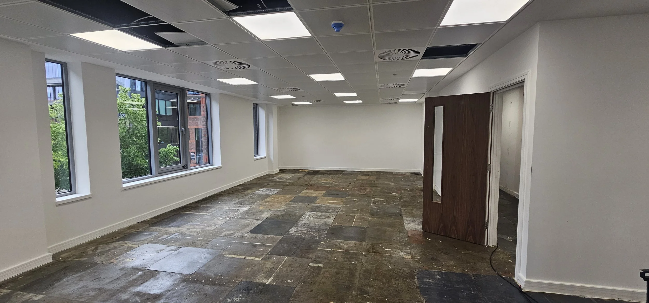 Removal solution soaking into raised access floor adhesive, Guildford commercial fit-out