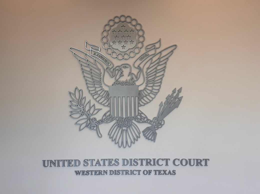 Seal of the United States District Court for the Western District of Texas on a wall.