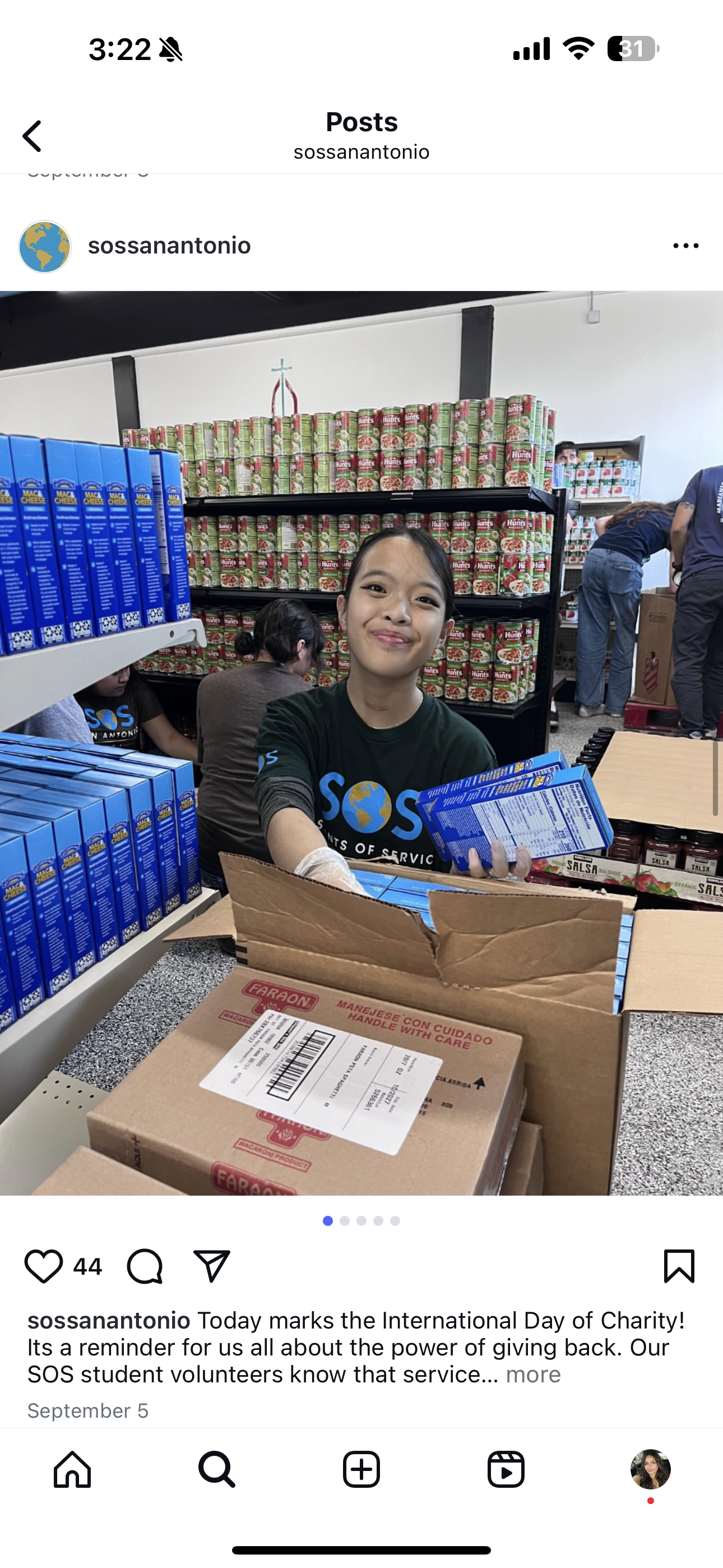 A young woman volunteering at a food bank, organizing canned goods on shelves.