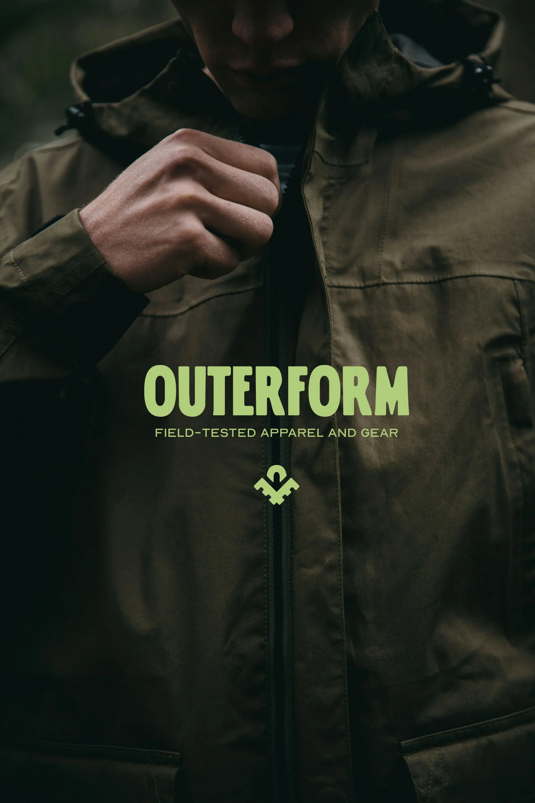 Close-up of man zippering a outdoor jacket with the logo and text 'OUTERFORM Field-Tested Apparel and Gear' on the front.