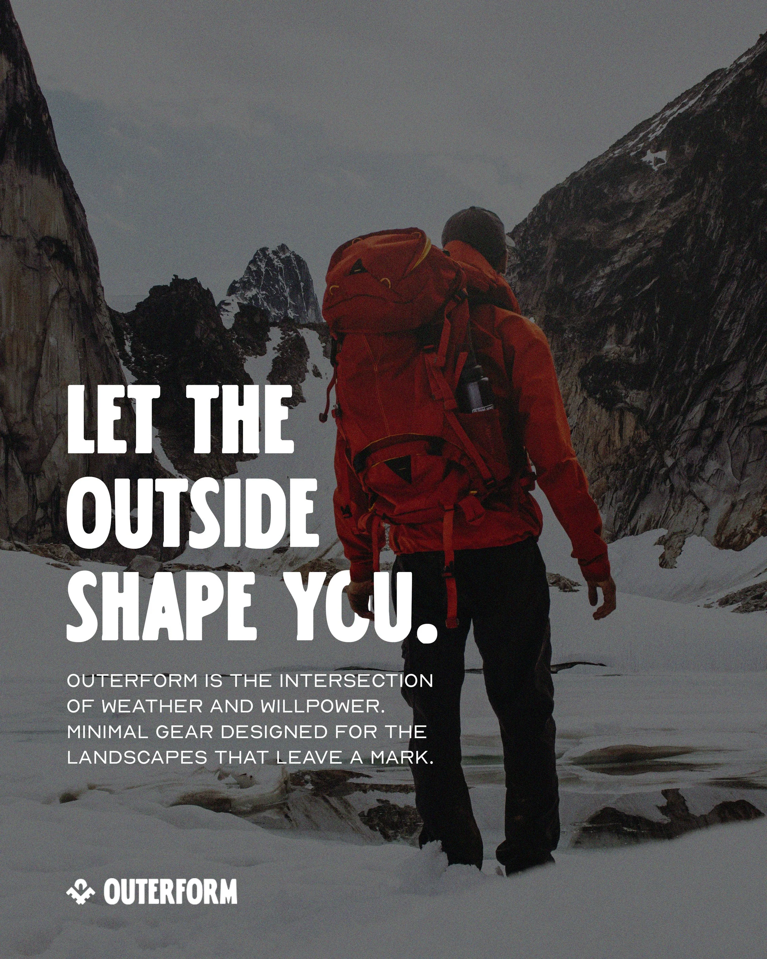 A person dressed in outdoor hiking gear with a large red backpack, standing in a snowy mountainous landscape with rocky peaks and cloudy sky in the background.