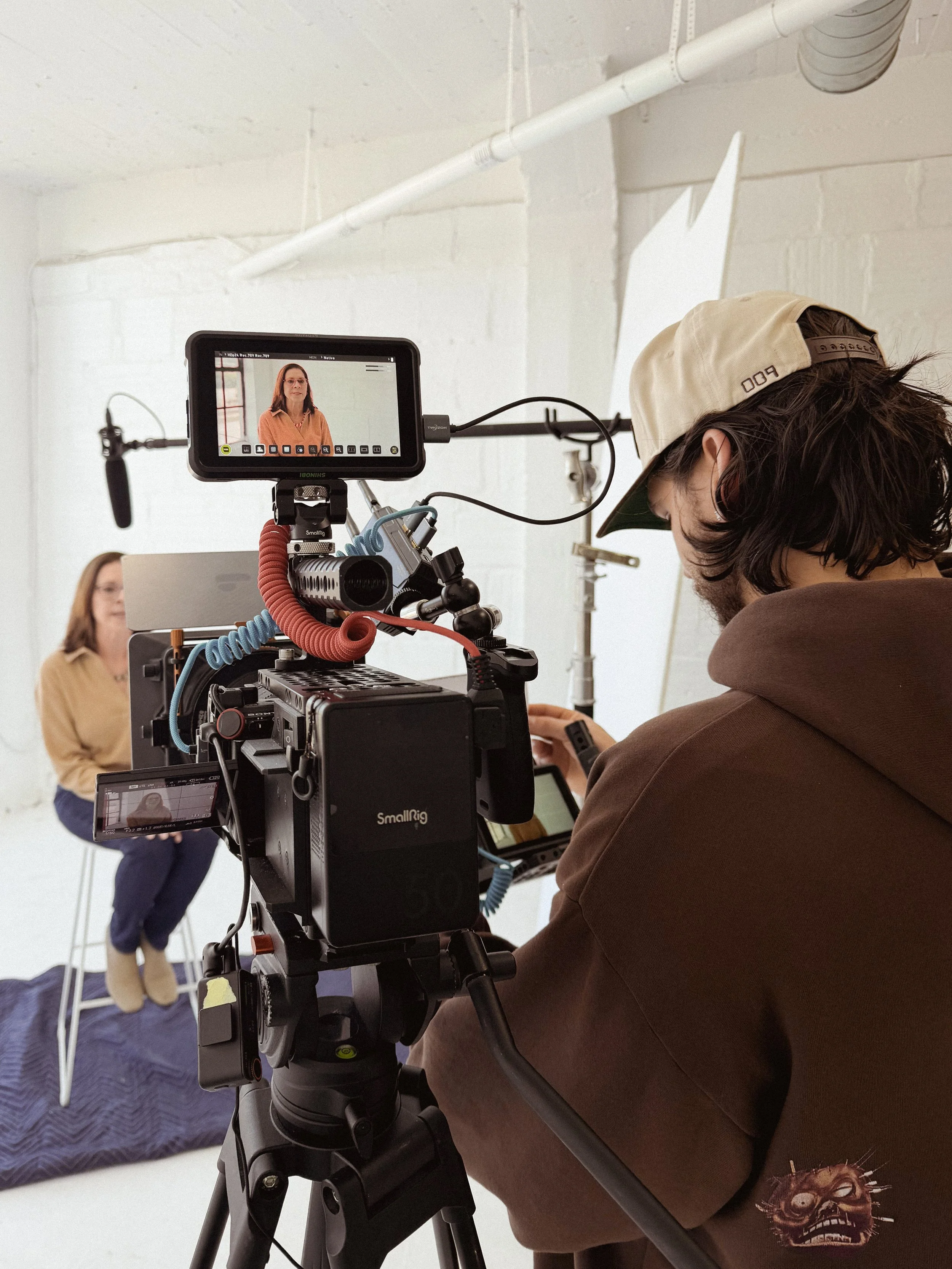 Professional videographer in Atlanta filming in a studio with lighting and camera equipment, used for corporate video production and commercial content creation.