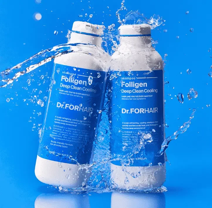 Two bottles of Dr. For Hair shampoo with water splashing around them, set against a blue background.
