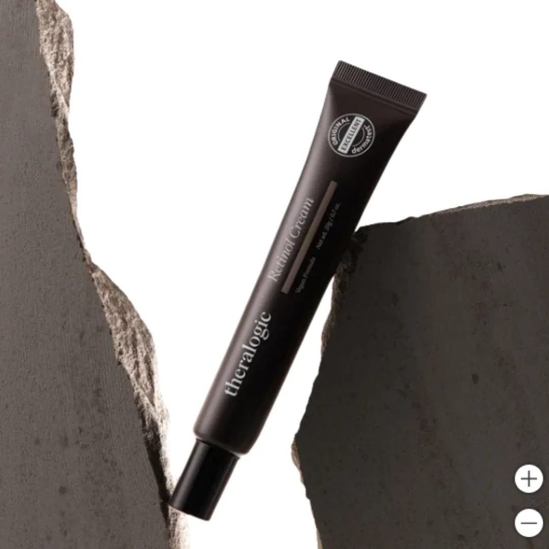 Tube of Theralogic Retinol Cream between two pieces of rough gray stone