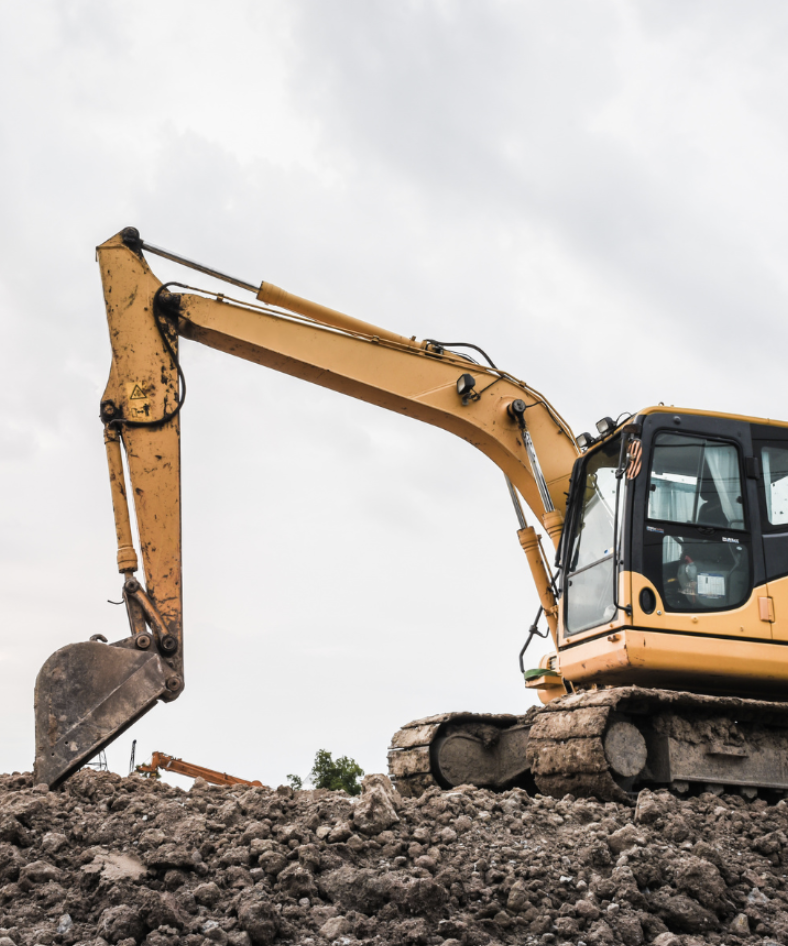 Skilled operator using excavator on commercial construction site