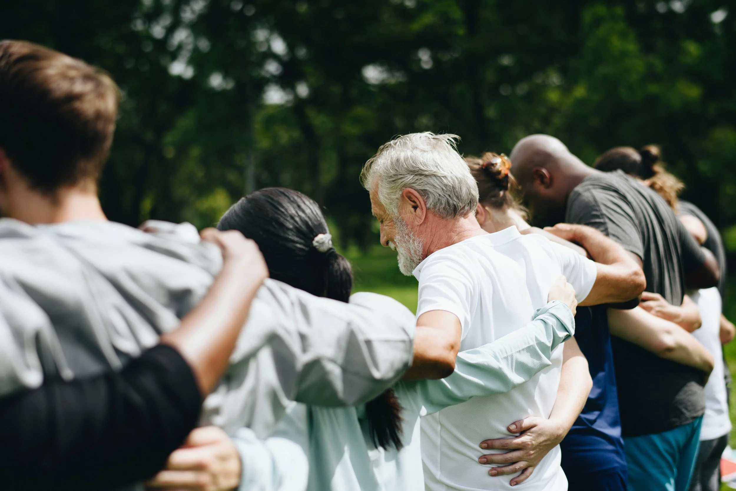 Group of people joined together in a circle