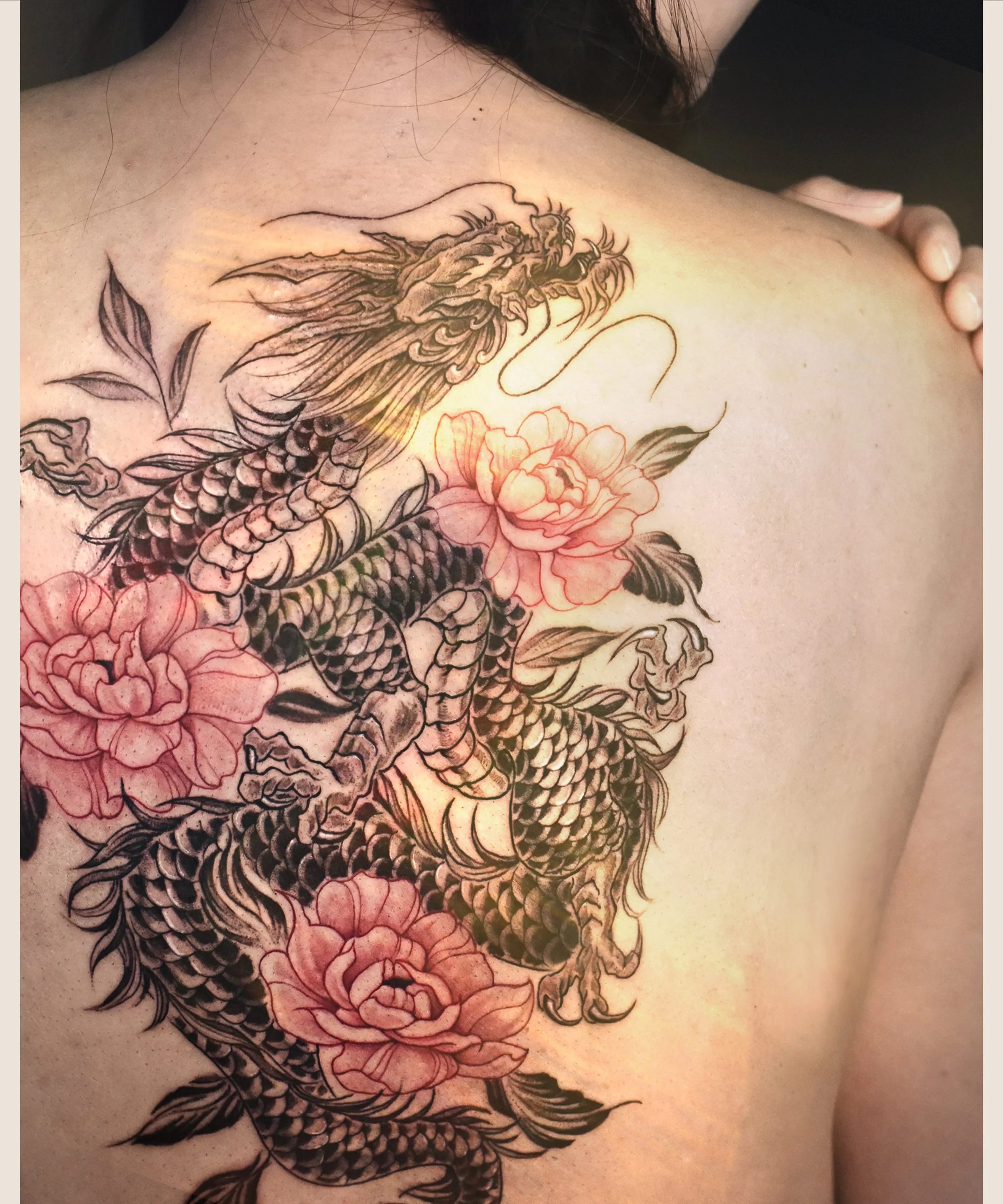 Back Dragon tattoo in black and red peony tattoo , craft and designed by Bored ink club, located in Los Angeles