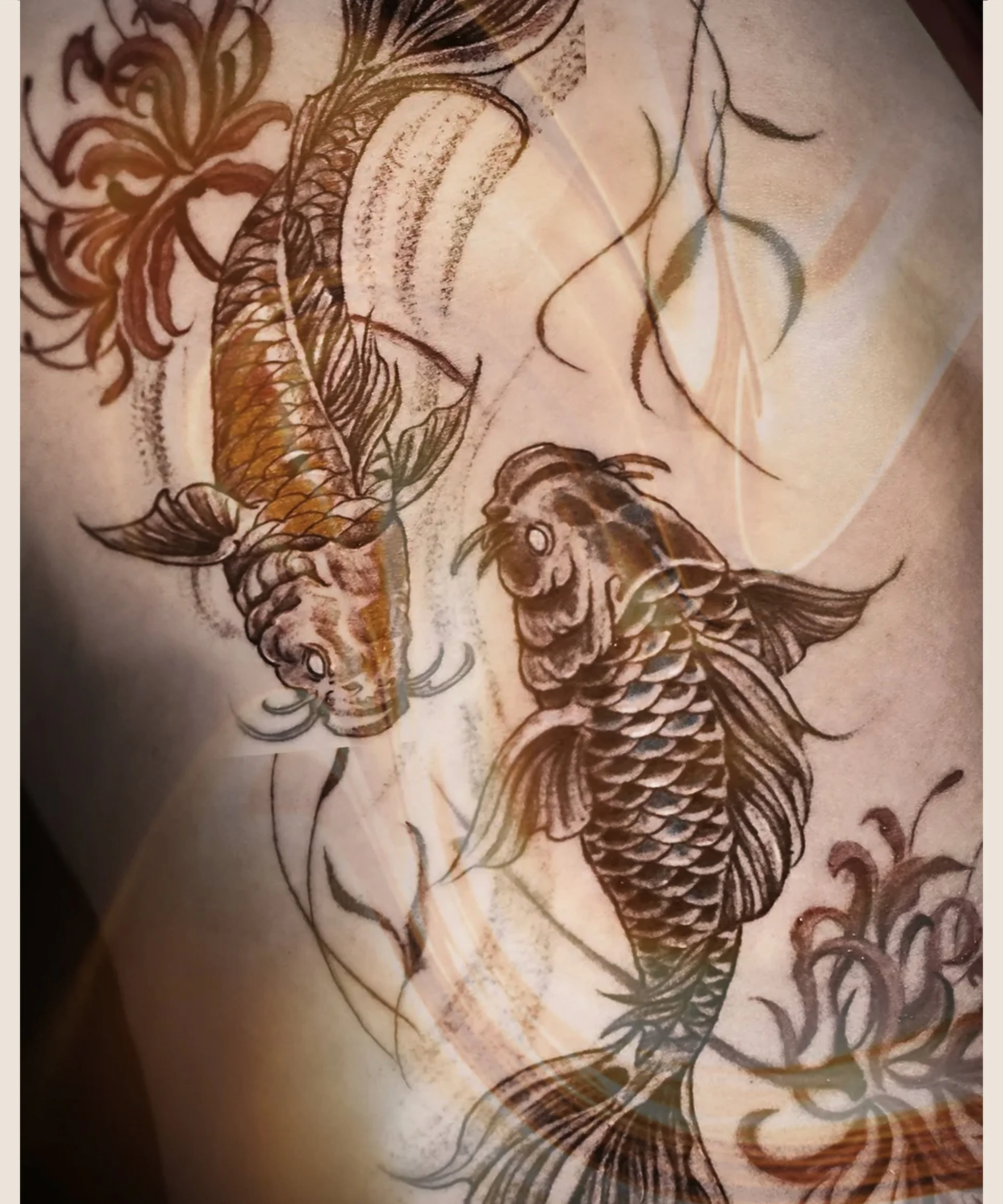 Asian Koi pair tattoo  swimming towards each other with spider lilies  by Bored ink club, located in Los Angeles