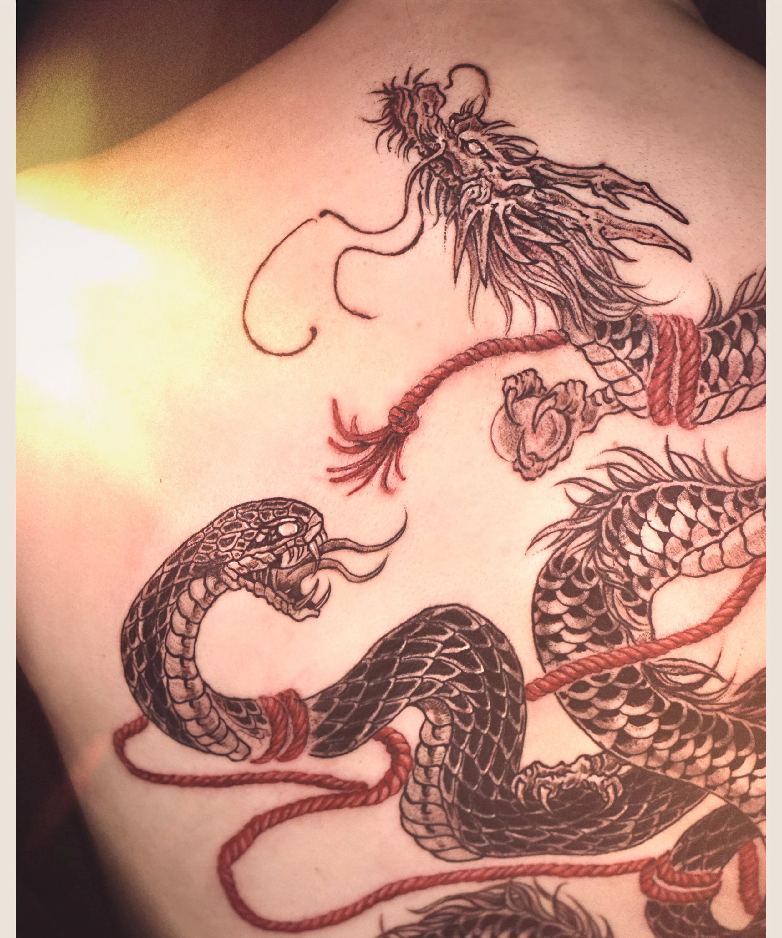 Dragon and Snake back tattoo, designed and crafted by Bored Ink Club, located in Los Angeles