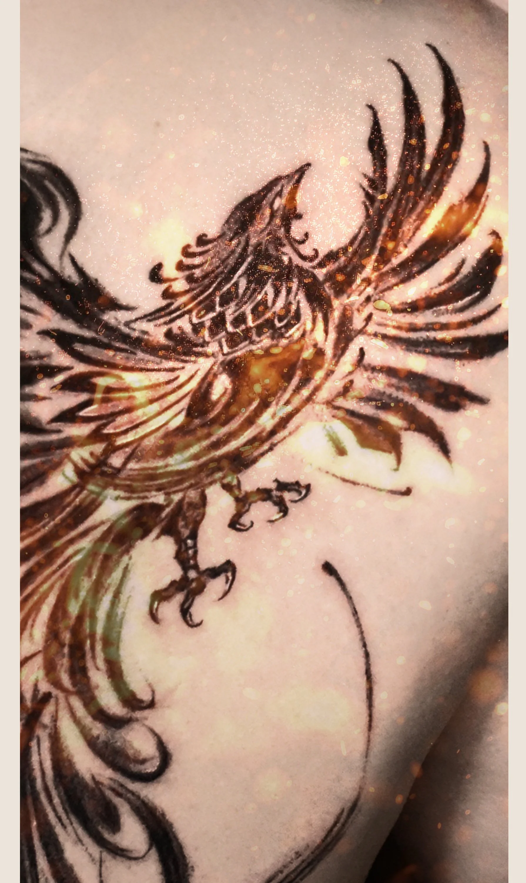 Close-up of a tattoo featuring a pheonix with brushstroke style