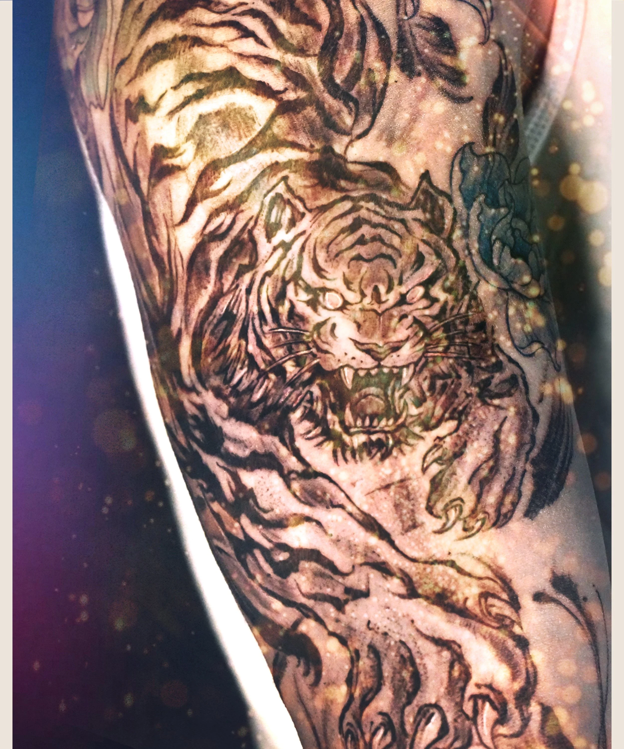 Asian tiger tattoo upper arm wcrafted and designed by Bored ink club, located in Los Angeles