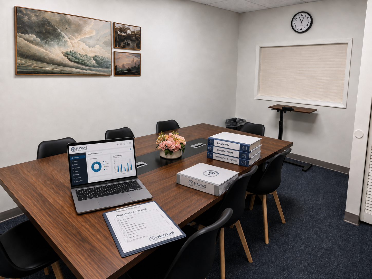 A conference room with a wooden table, black chairs, a laptop displaying graphs and charts, a flower arrangement, various binders, a study checklist, subway tiles on the wall, a window with closed blinds, a wall clock showing 11:55, a trash bin, and a standing desk in the corner.