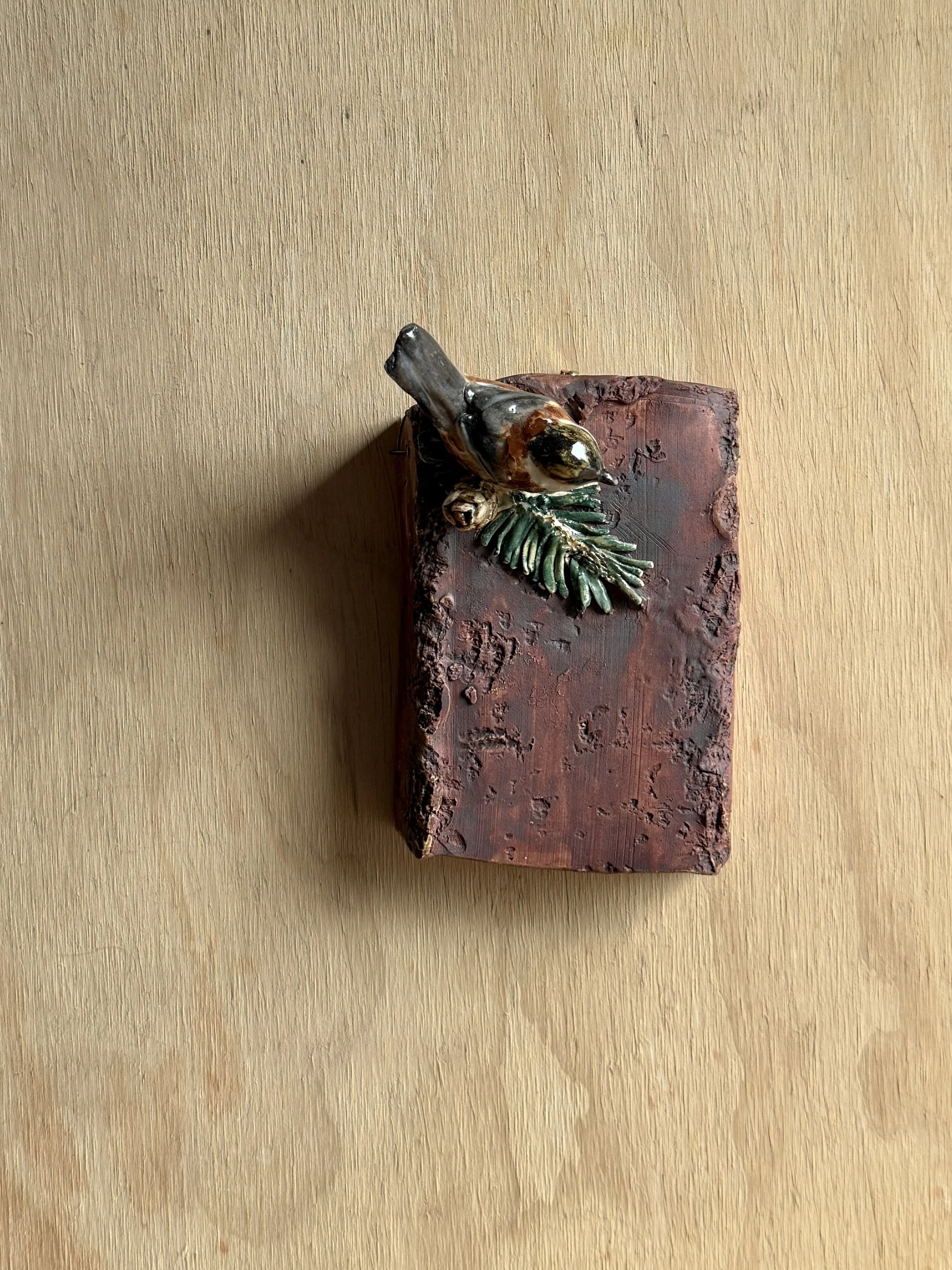 Chestnut-backed Chickadee on wall plaque