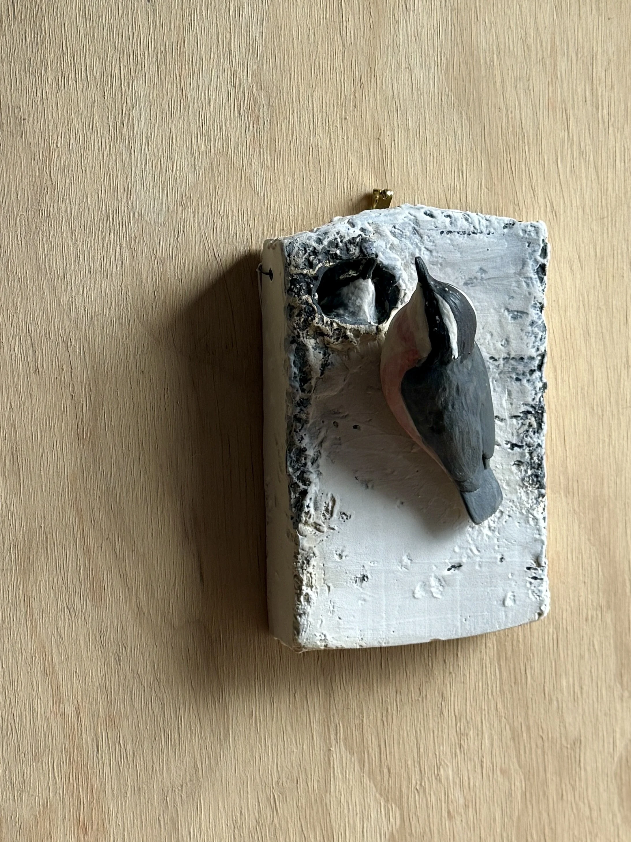 Red-breasted Nuthatch on wall plaque