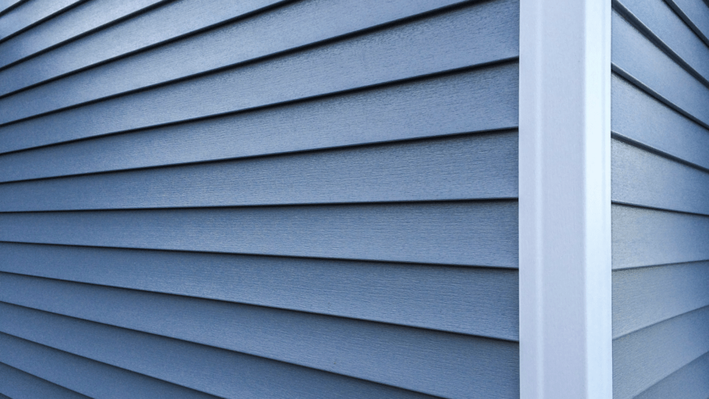 Close-up of blue house siding with horizontal vinyl panels.