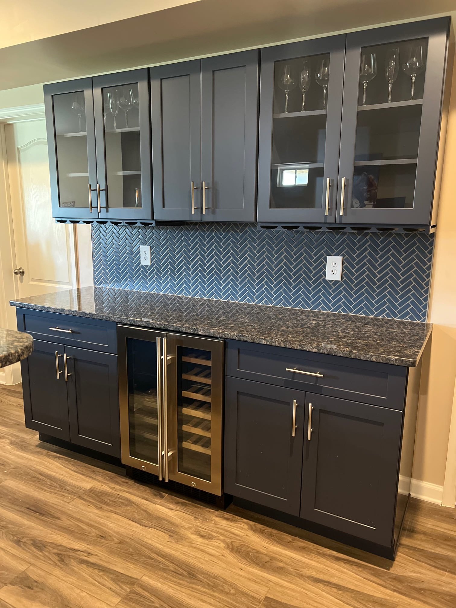 Basement bar installation with custom cabinets, wine fridge, and herringbone backsplash – Tampa handyman project