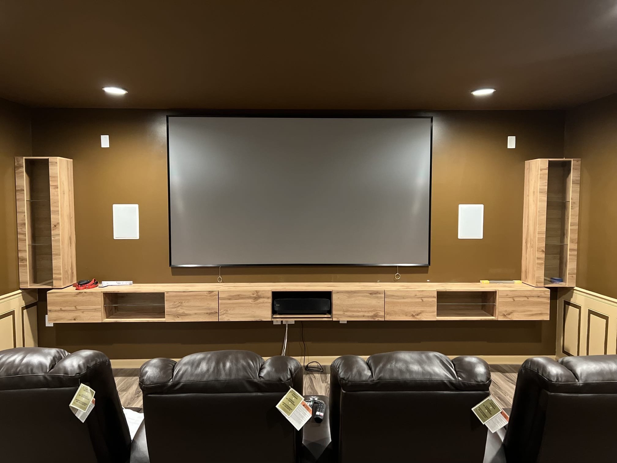 We helped create a custom basement theater with built-in media storage, surround sound wiring, and a wall-mounted projection screen — built for relaxation and entertainment.