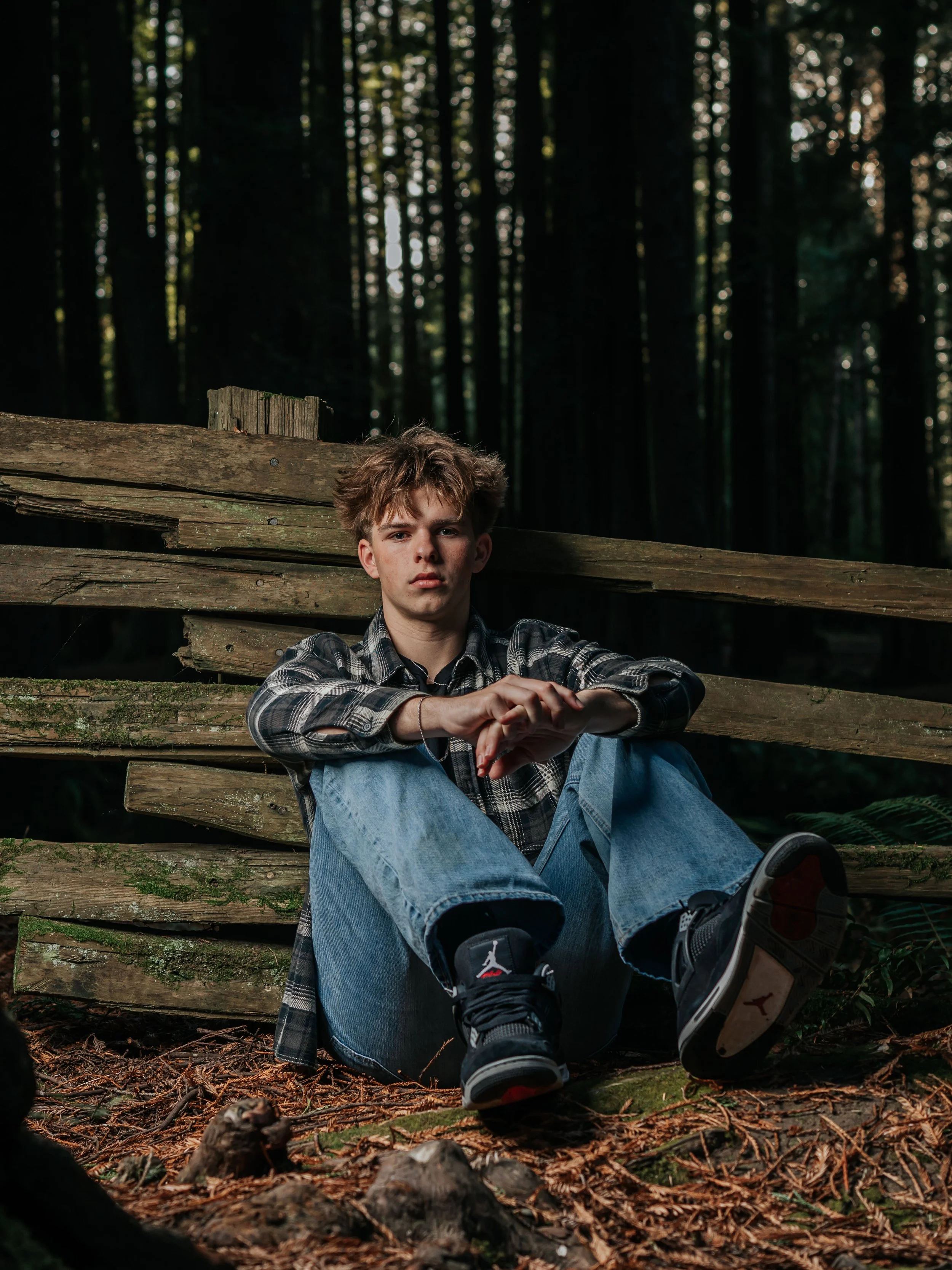 Humboldt County senior portrait of a young man sitting on rustic wooden steps in a redwood forest by Tex Kelly Productions
