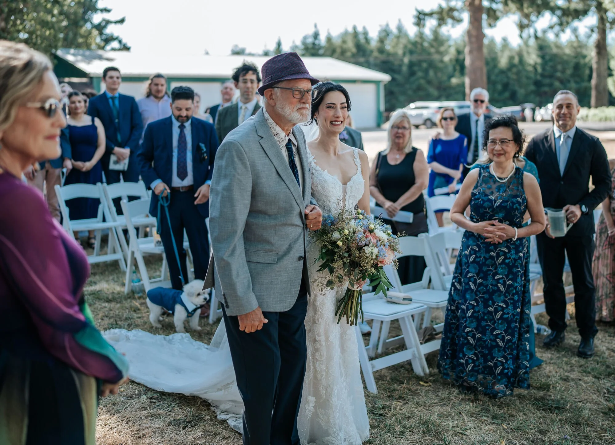 Wedding guests gathered for the ceremony at a scenic Humboldt County venue. Family and friends celebrate love in Northern California. Wedding photography by Tex Kelly Photography.