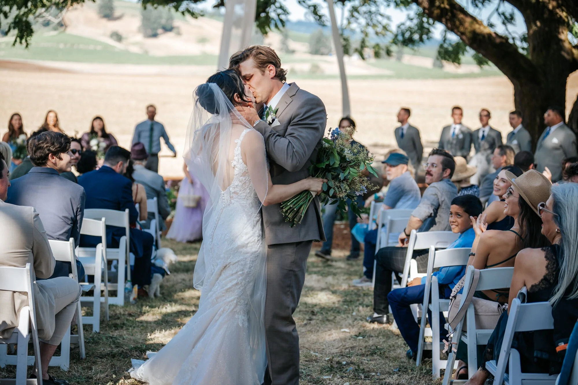 Wedding recessional as newlyweds walk down the aisle together in Humboldt County. Joyful moment after saying I do captured by Tex Kelly, elopement and wedding photographer.