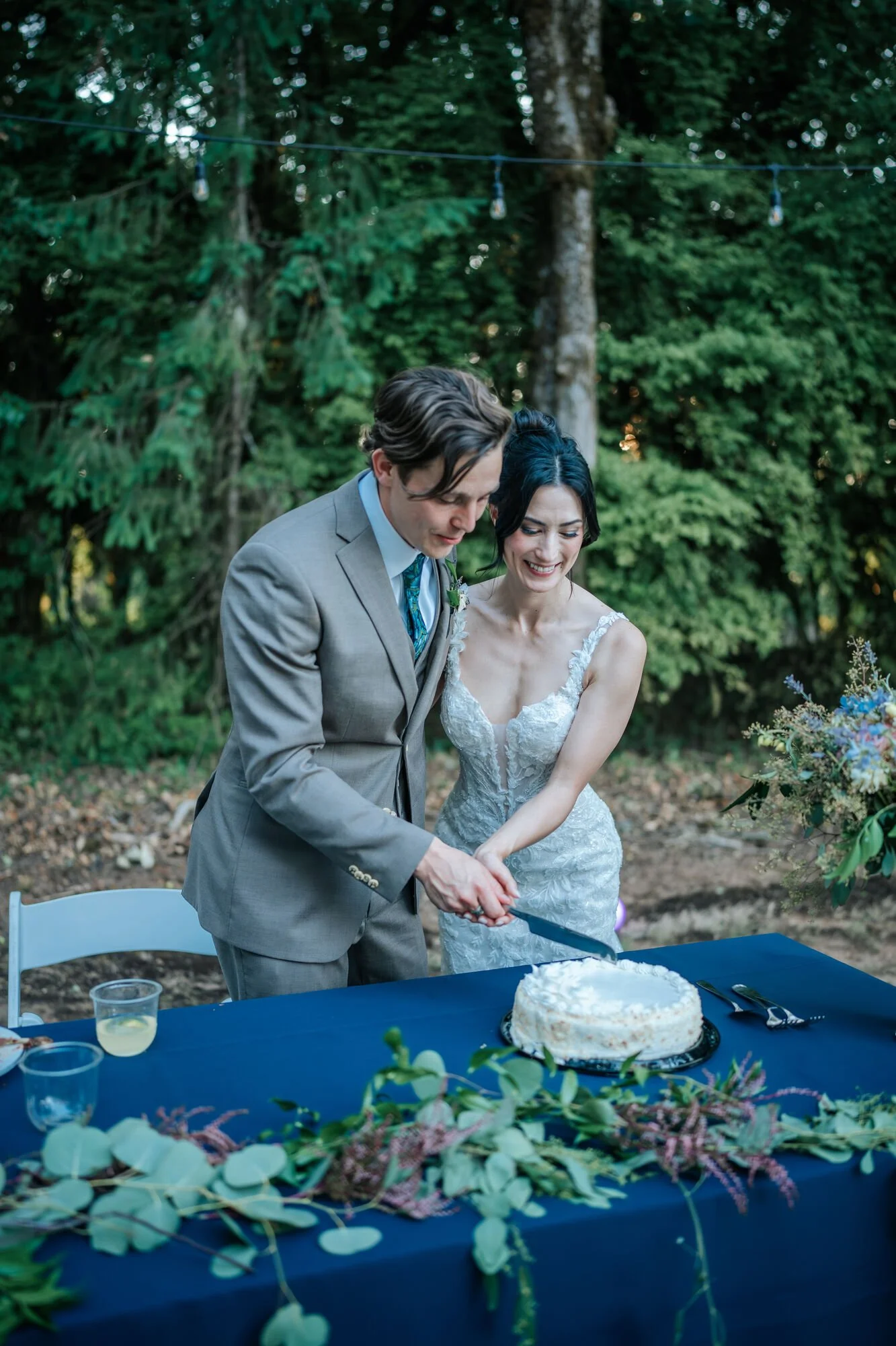 Bride and groom cut their wedding cake at a Humboldt County reception. Classic wedding reception moment captured by Tex Kelly, Arcata and Eureka wedding photographer.