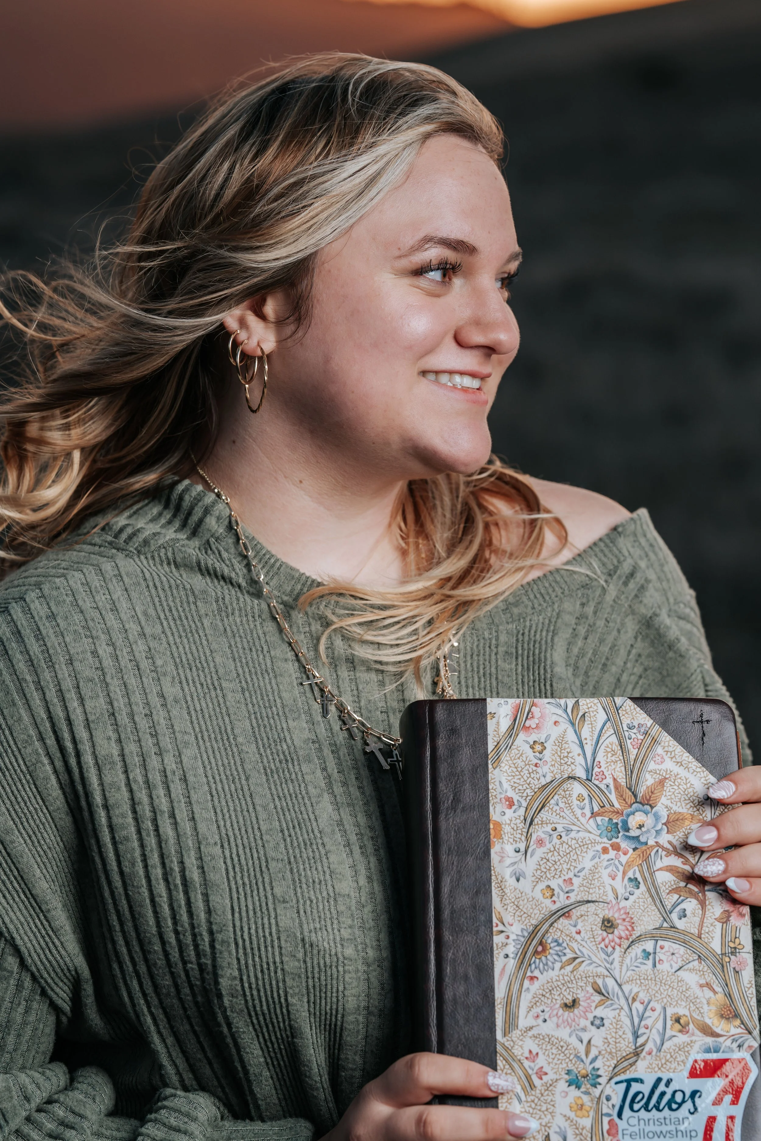 Elegant senior portrait of a young woman with a book in golden hour light in Humboldt County by Tex Kelly Productions