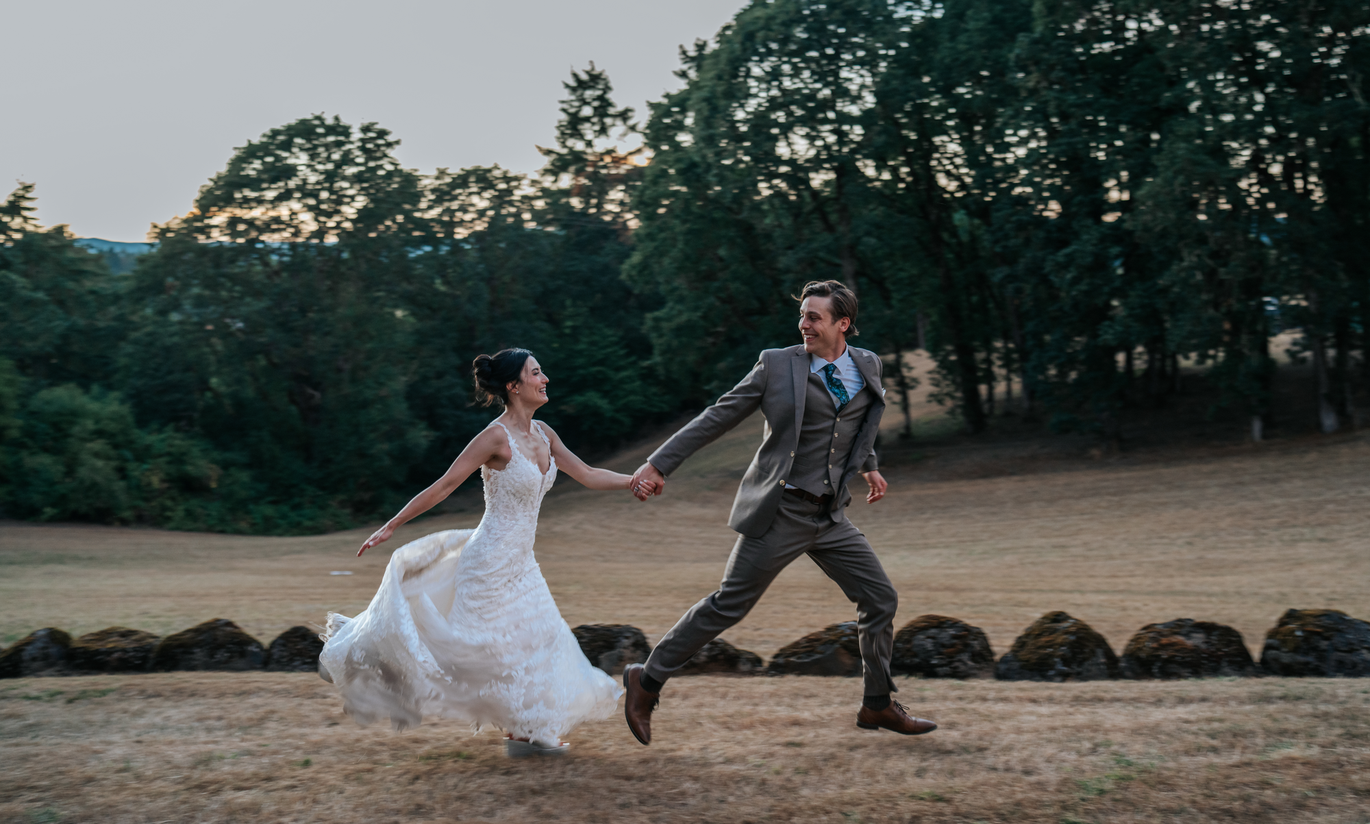 Tex Kelly Productions golden hour wedding photography — bride and groom dancing joyfully in a field in Humboldt County, Fortuna wedding photographer