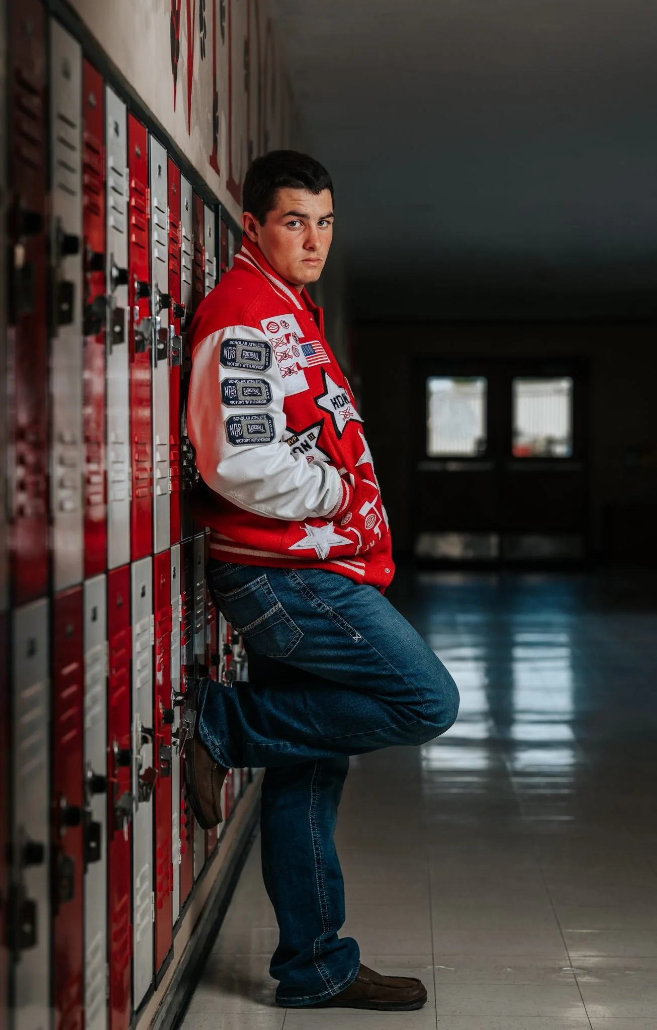 Ferndale High School senior Tanner Pidgeon leaning against school lockers during senior portrait session by Tex Kelly Productions"